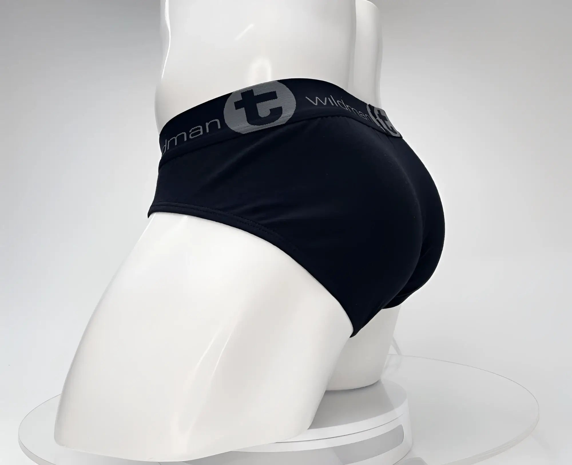 Black wildmant cotton briefs with a gray elastic waistband featuring wildman brand logo and lettering