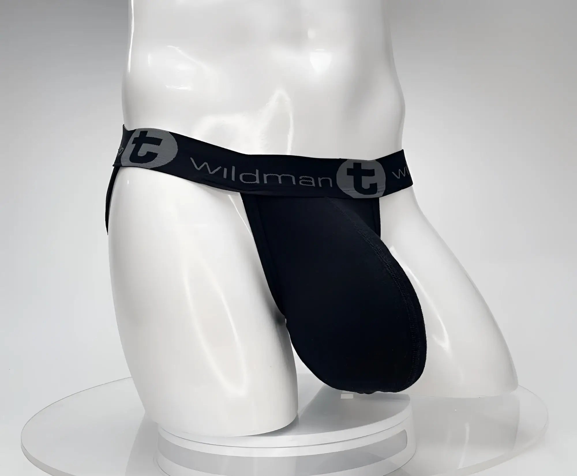 Black wildman cotton monster cock jockstrap with stretchy elastic waistband featuring wildman logo and gray circular t emblem