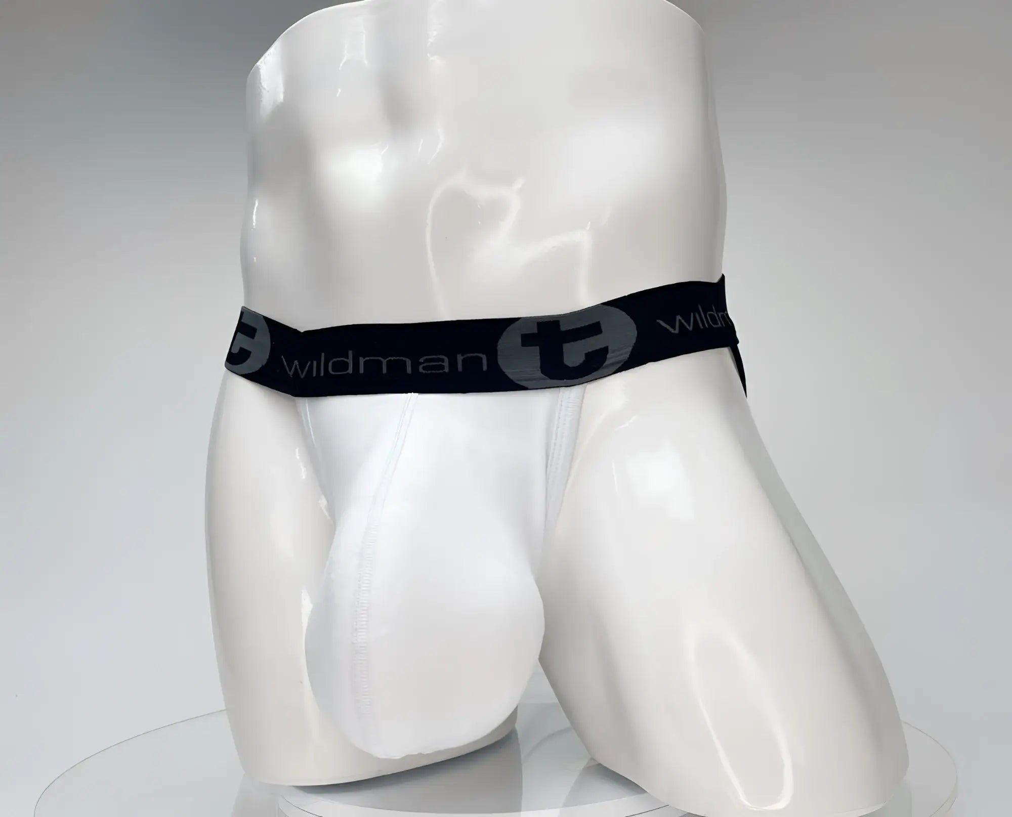 White wildmant cotton monster cock jockstrap with black elastic waistband featuring wildman logo and stylized t emblem