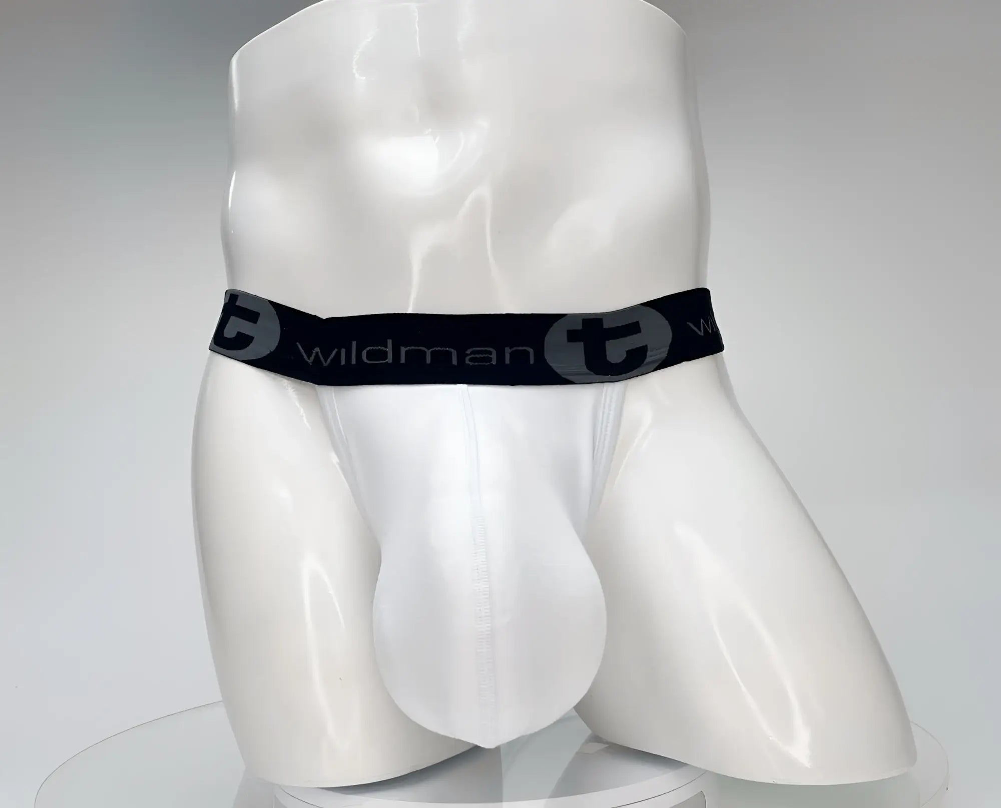 White wildman cotton monster cock jockstrap briefs with black elastic waistband and wildman logo and stylized t emblem