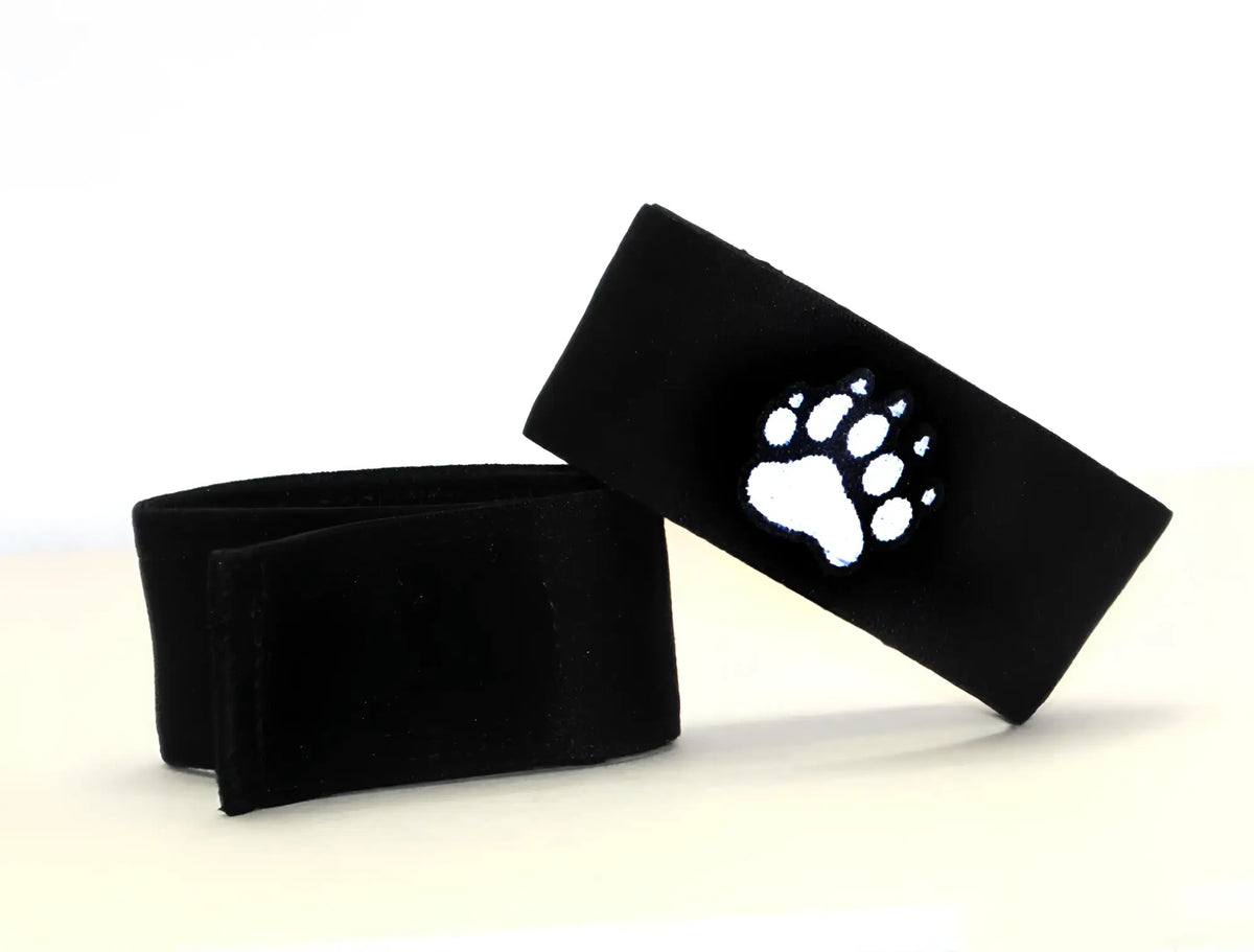 Black felt wristband with a white embroidered paw print design from wildmant fetish max cock ring bear collection