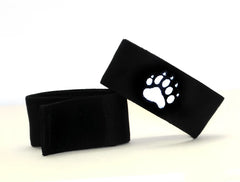 Black felt wristband with a white embroidered paw print design from wildmant fetish max cock ring bear collection