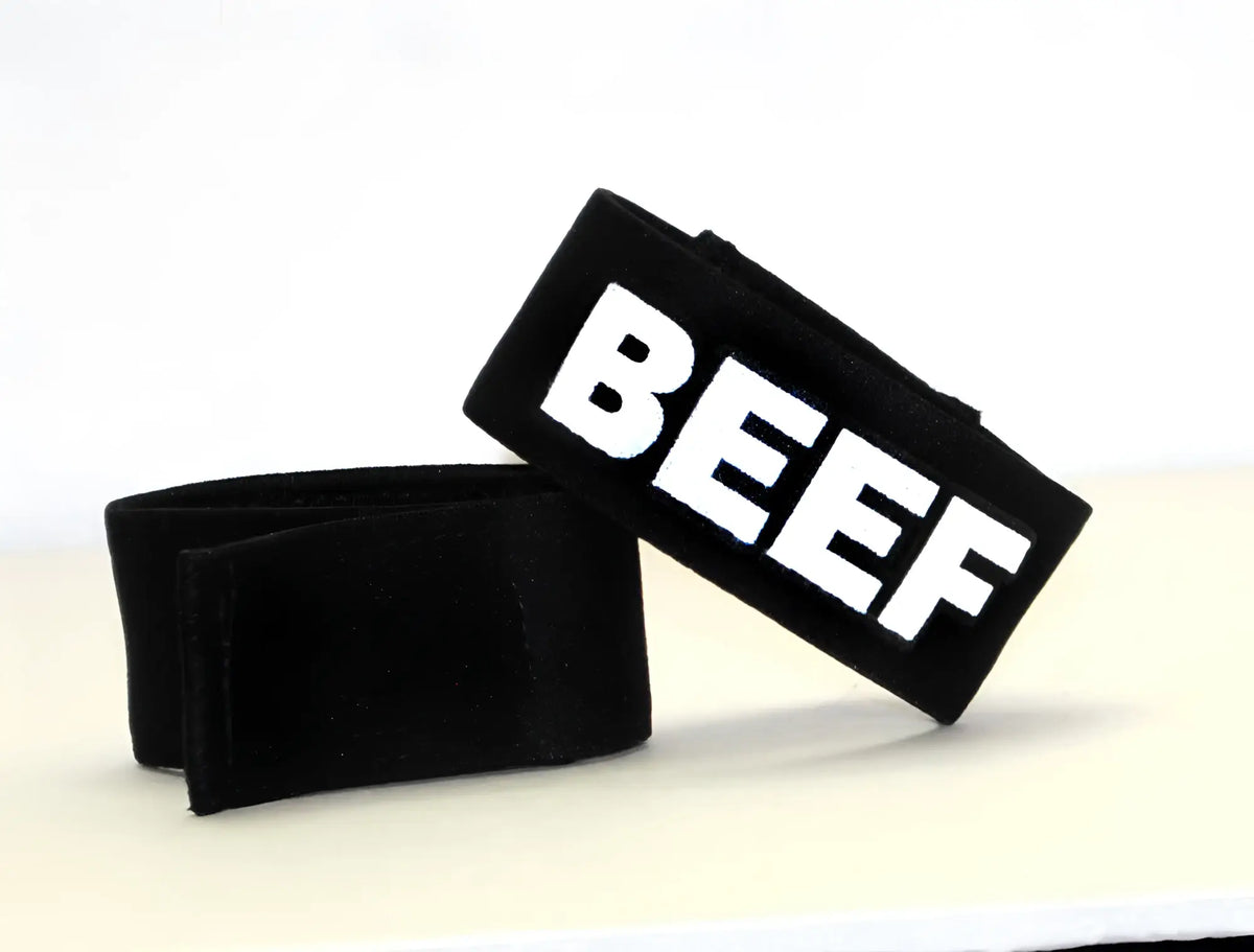 Black fabric wristband with bold white beef lettering for wildmant fetish max cock-ring beef product
