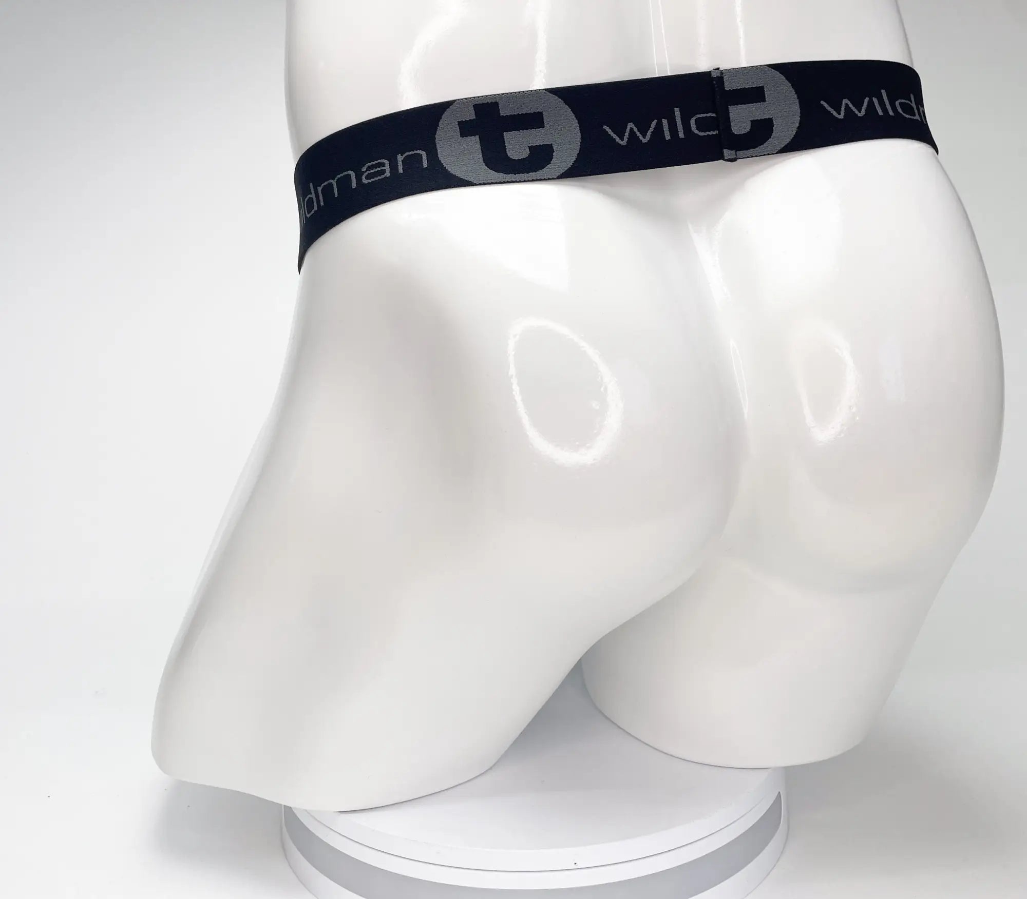 Black elastic waistband with gray wildman branding on mesh monster cock strapless pouch displayed on white mannequin