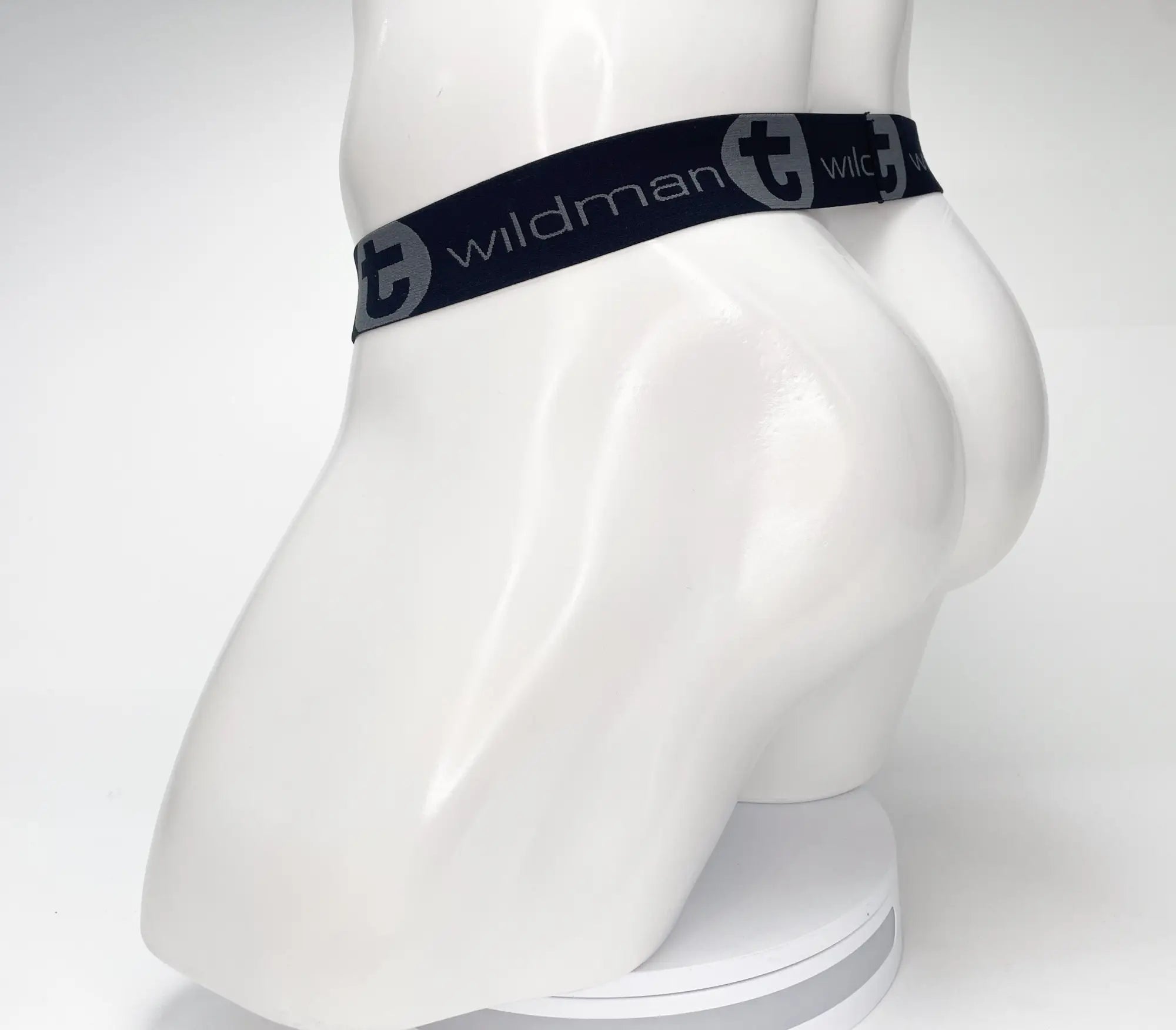 Black elastic waistband with wildman branding and circular logo on mesh monster cock strapless pouch black displayed on mannequin