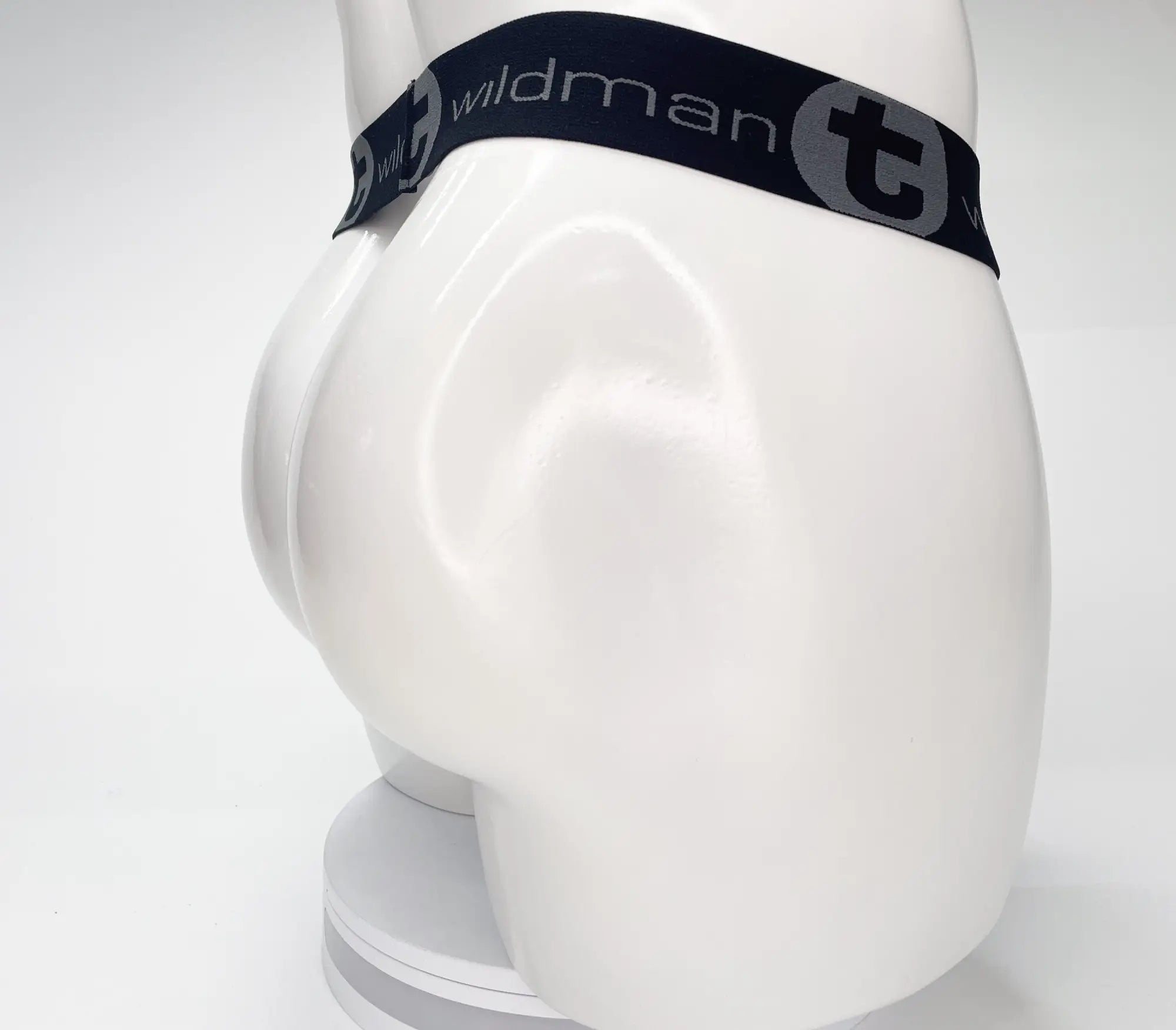 Wildmant mesh monster cock strapless pouch black with elastic waistband and gray wildman branding on white mannequin