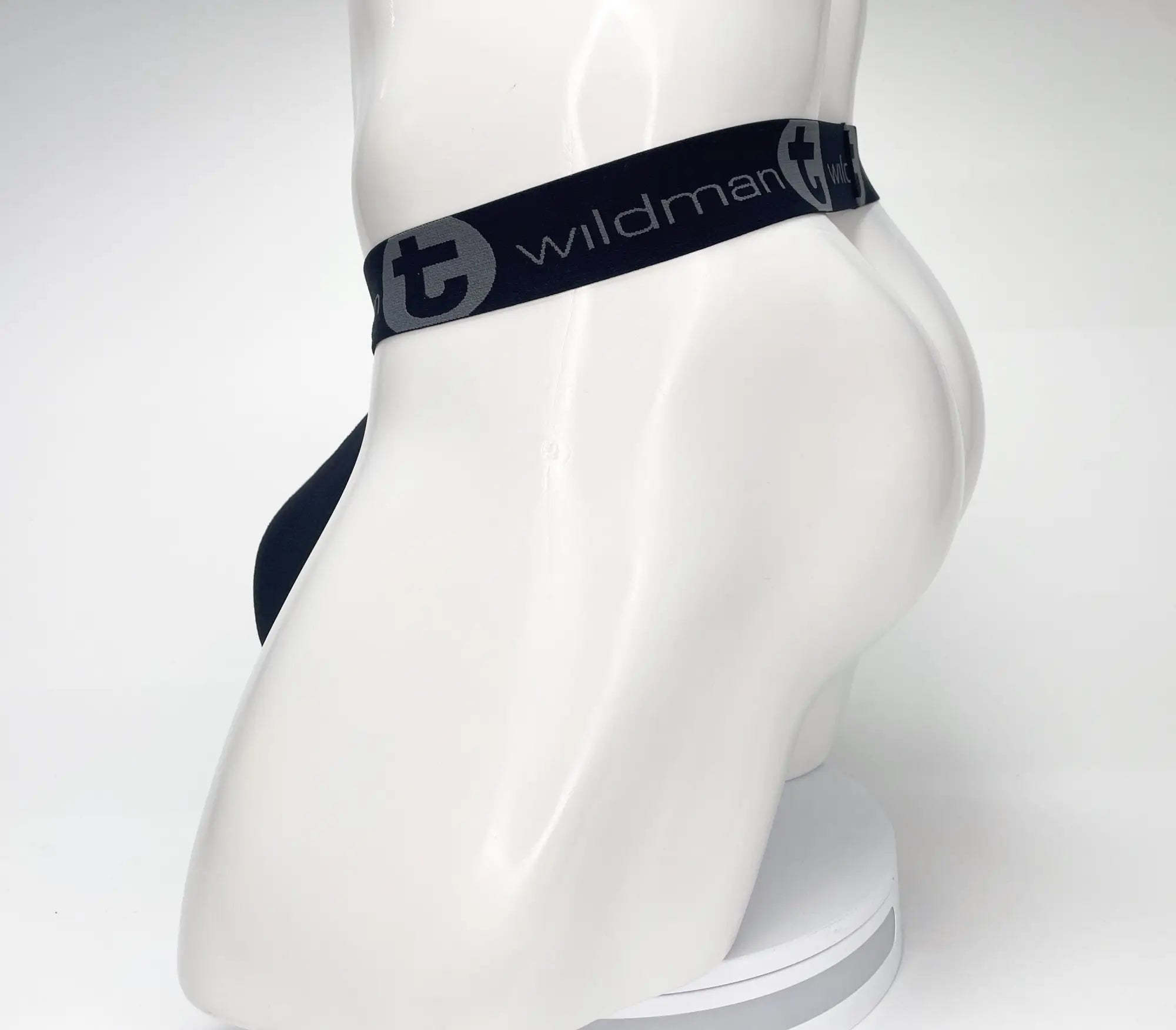 Navy blue wildman brand briefs with black elastic waistband featuring white logo for mesh monster cock strapless pouch use