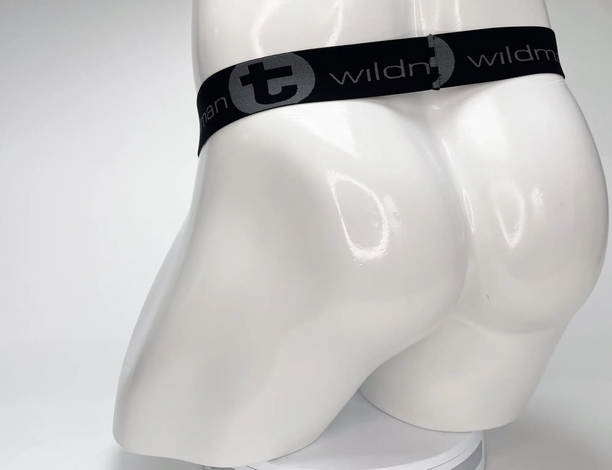 Black elastic waistband with gray wildman logo on white wildmant mesh monster cock strapless pouch product