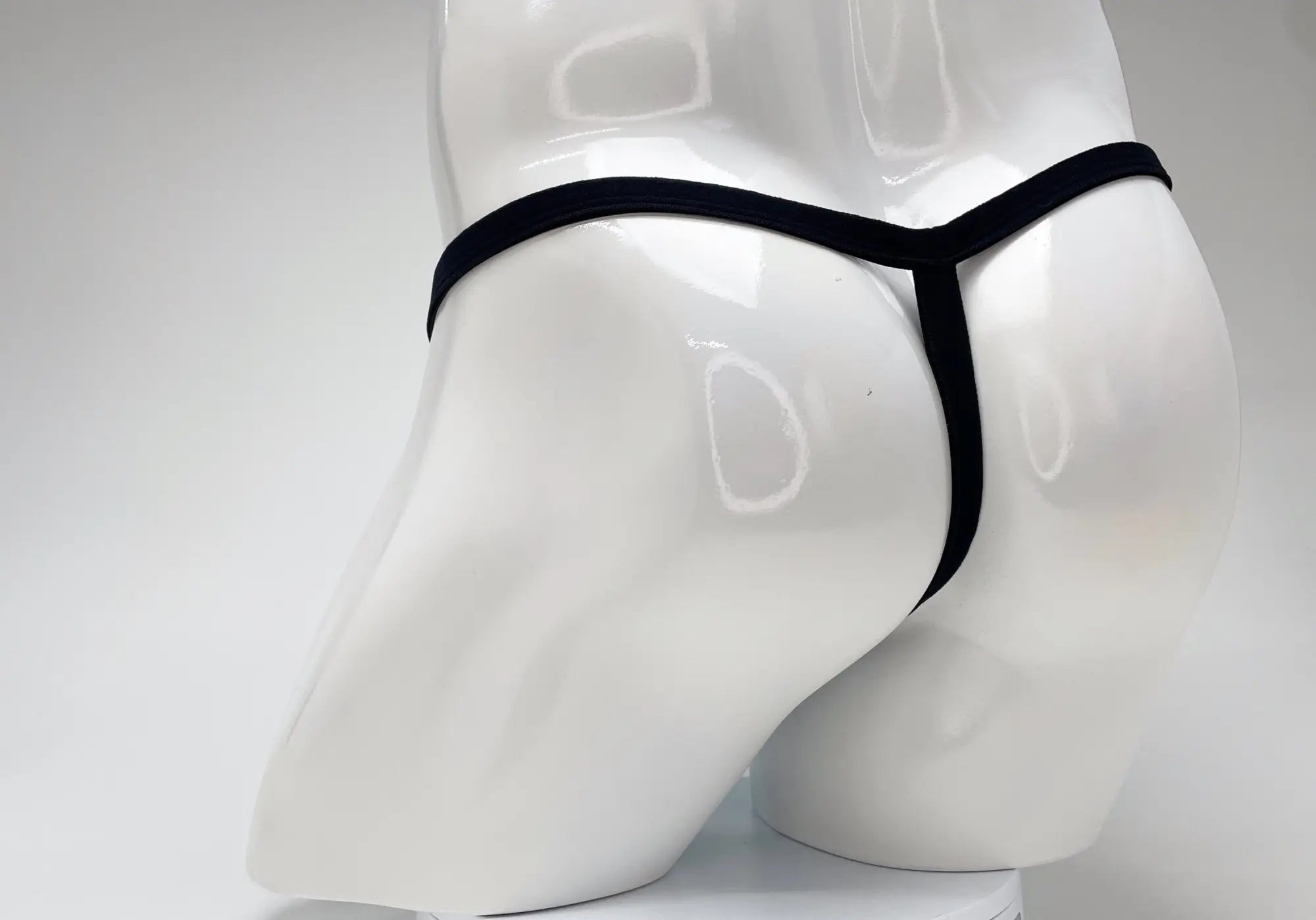 Black wildmant modal micro thong with big boy pouch displayed on white mannequin in baby blue color