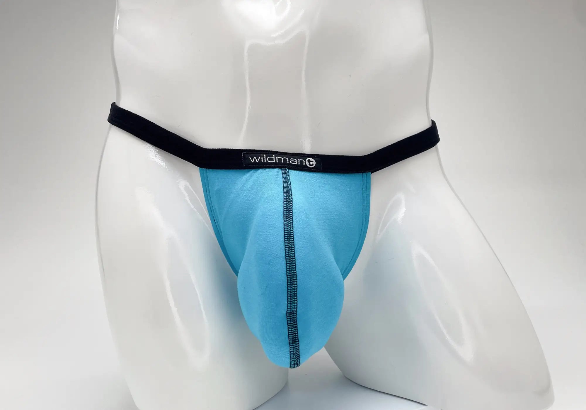 Light blue seamless wildmant modal micro thong with black elastic waistband and big boy pouch for athletic use