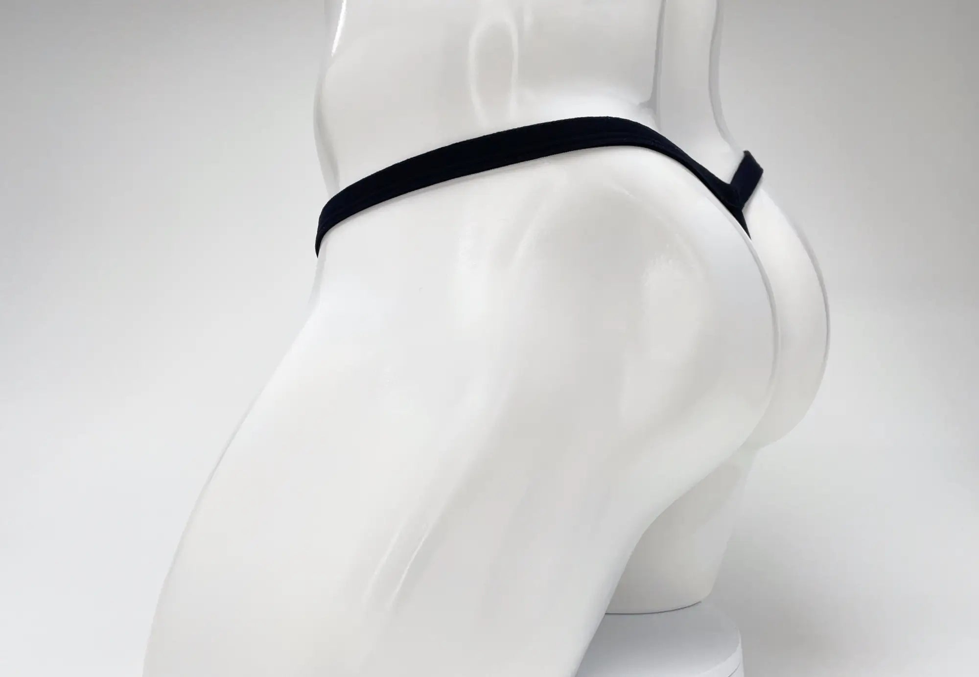 Black elastic waistband thong wildmant modal micro thong big boy pouch gold displayed on white mannequin front view