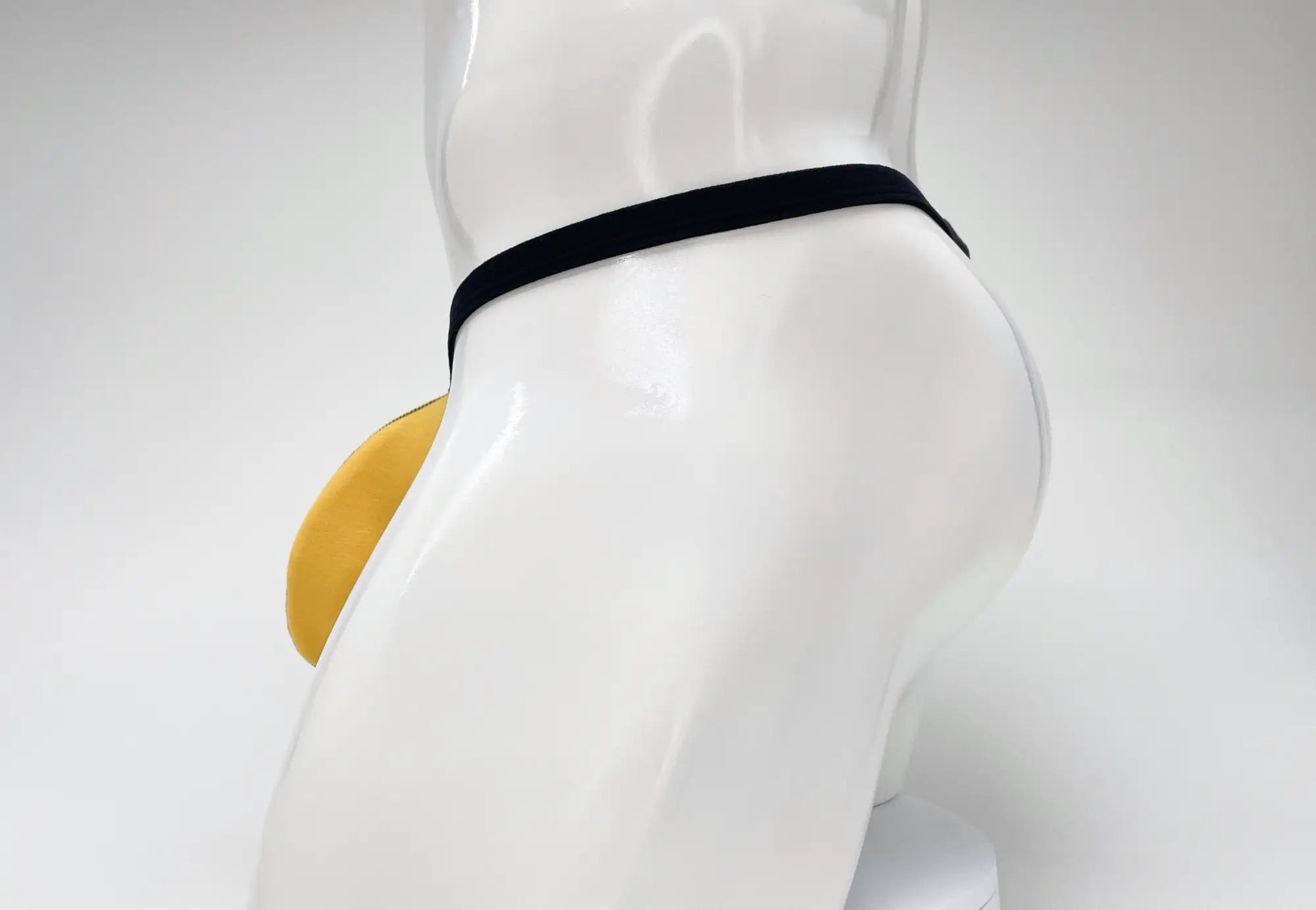 Wildmant modal micro thong with black elastic waistband and yellow padded gold pouch for big boy support