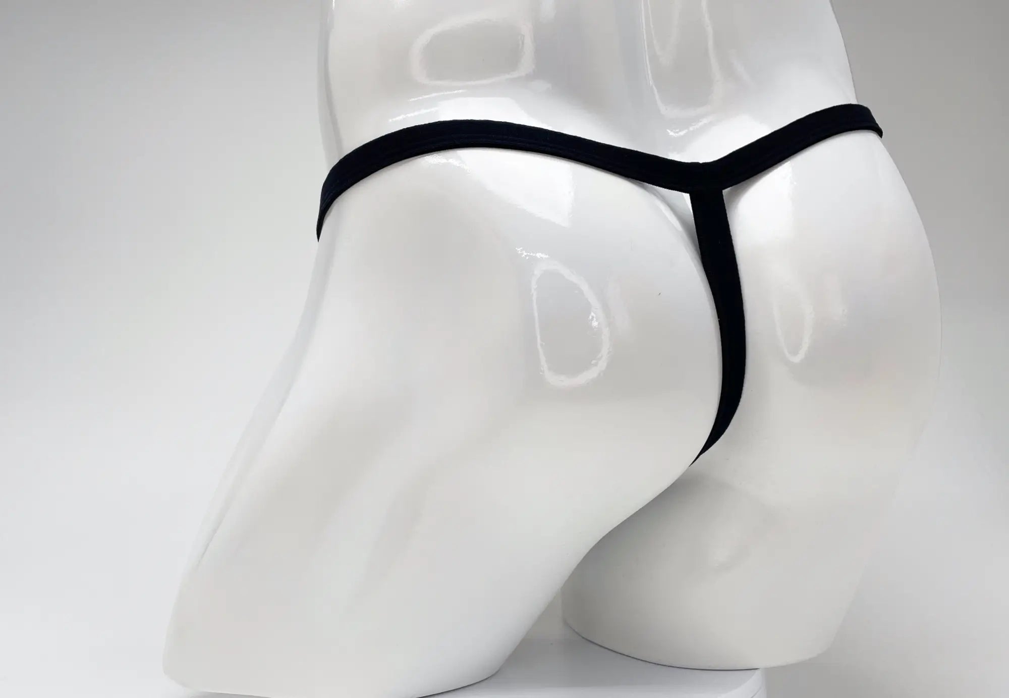 Black WildmanT modal micro thong with big boy pouch displayed on white mannequin