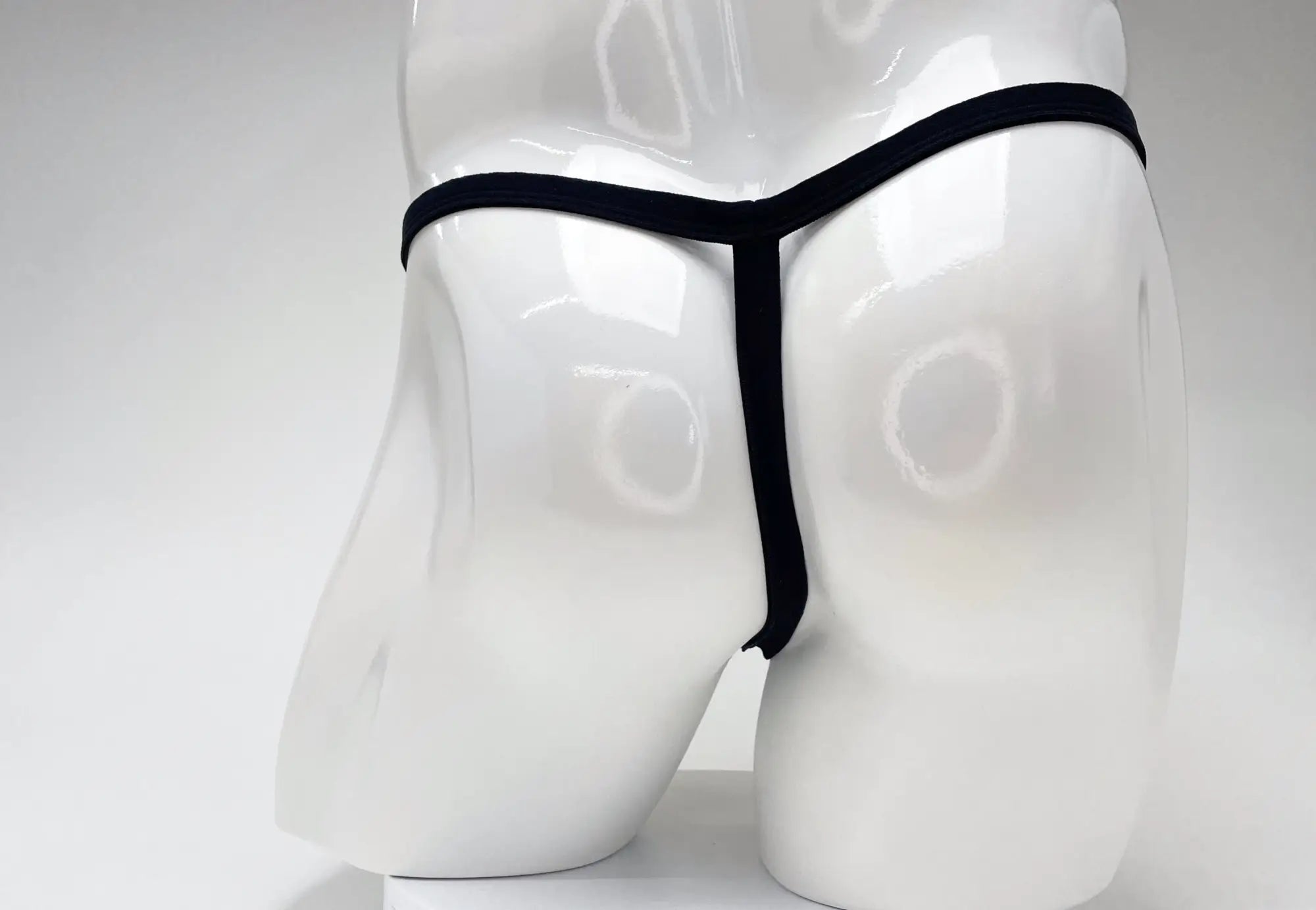 Black thong wildmant modal micro thong big boy pouch gold displayed on white mannequin front view