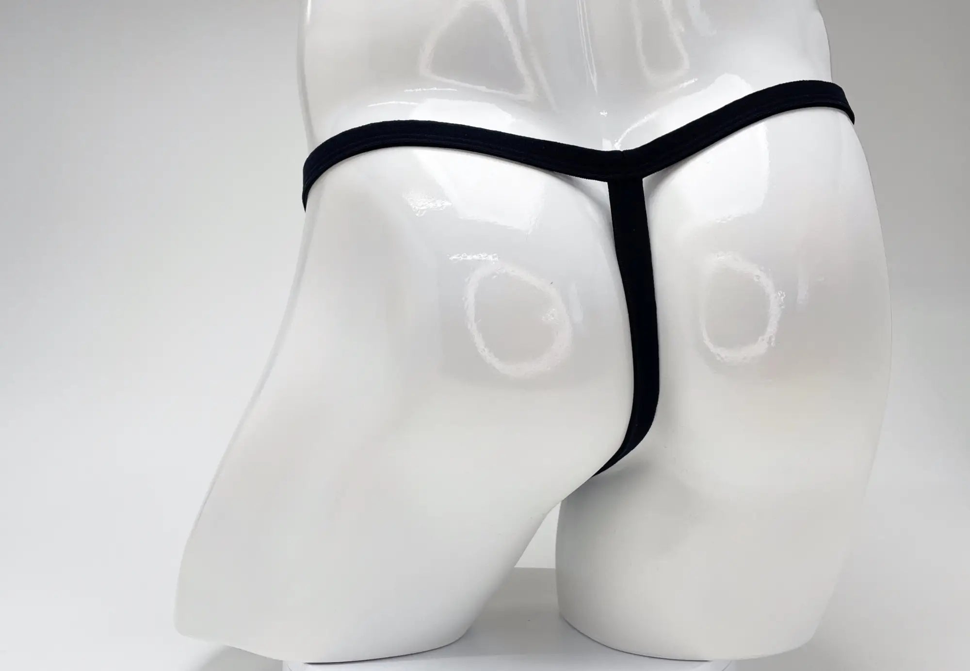 Black wildmant modal micro thong with big boy pouch displayed on white mannequin front view