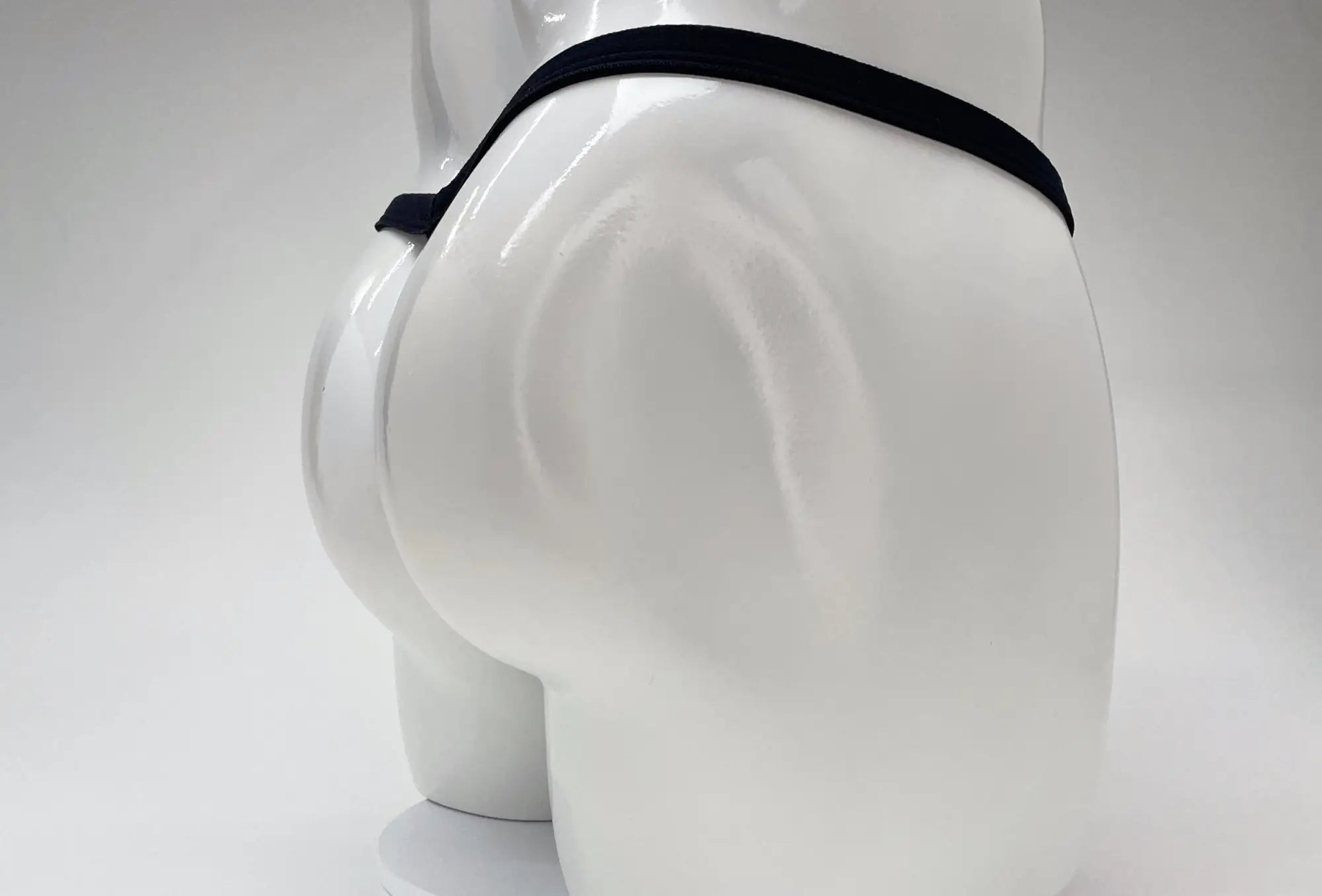 Black elastic waistband wildmant modal micro thong with big boy pouch displayed on white mannequin front view