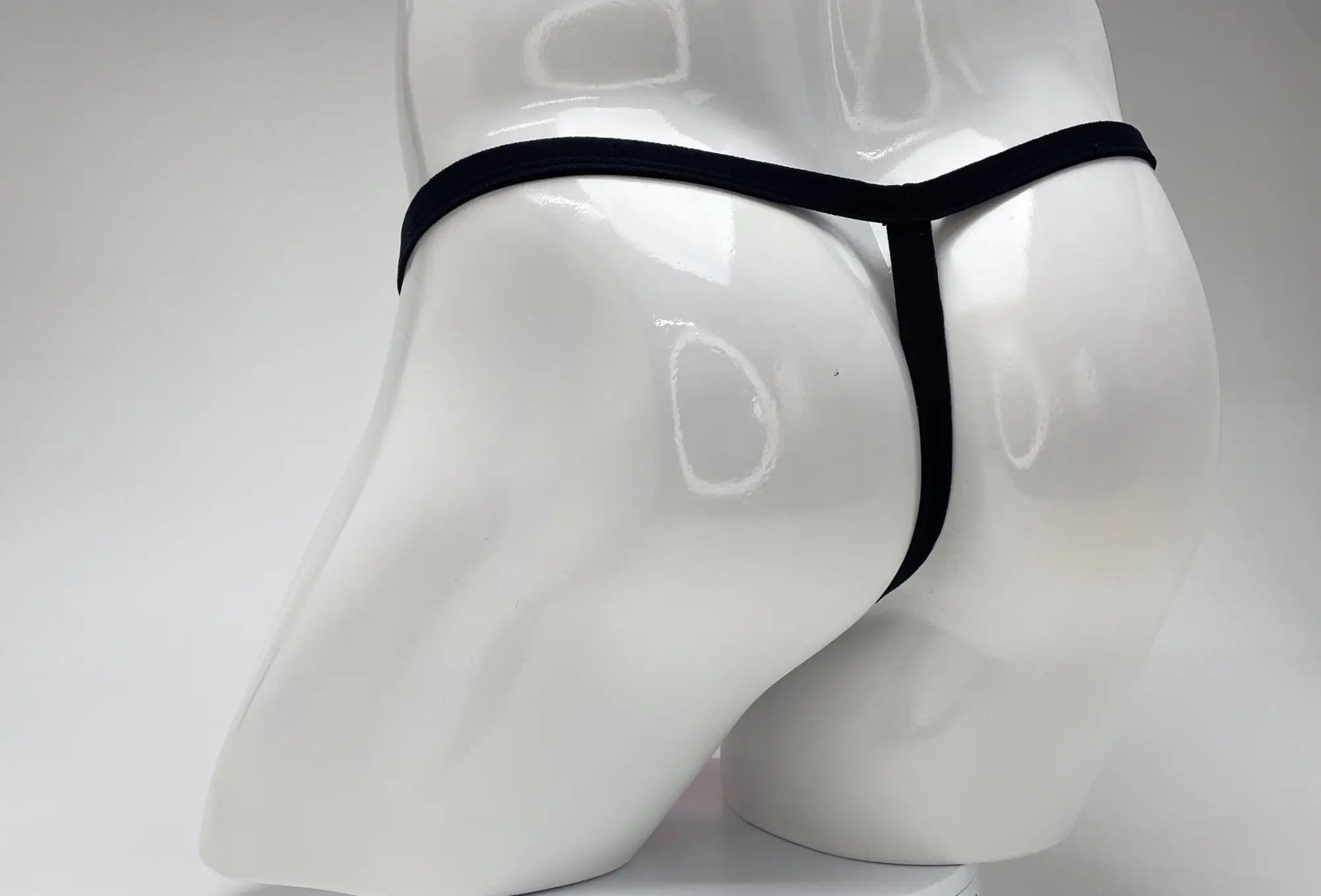 Black wildmant modal micro thong with big boy pouch displayed on white mannequin front view