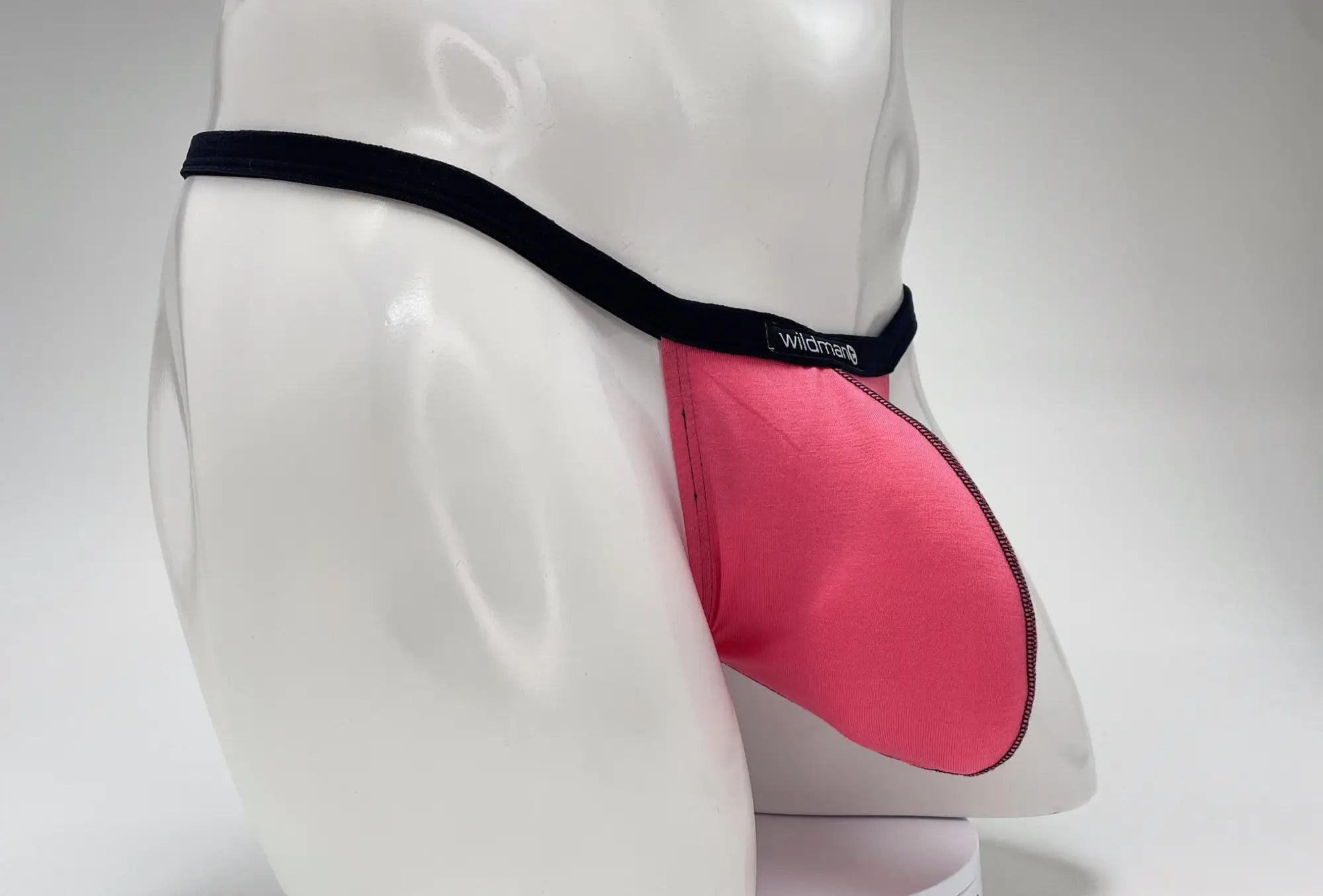 Pink modal micro thong briefs with black elastic wildman waistband featuring big boy pouch detail