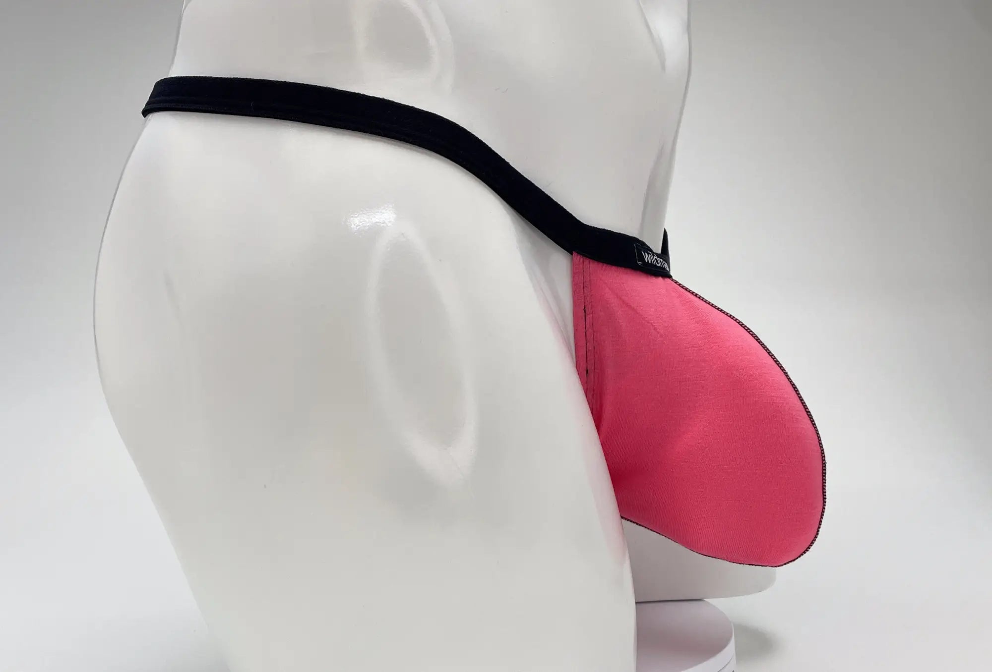 WildmanT modal micro thong big boy pouch in pink fabric with black elastic waistband for comfortable support