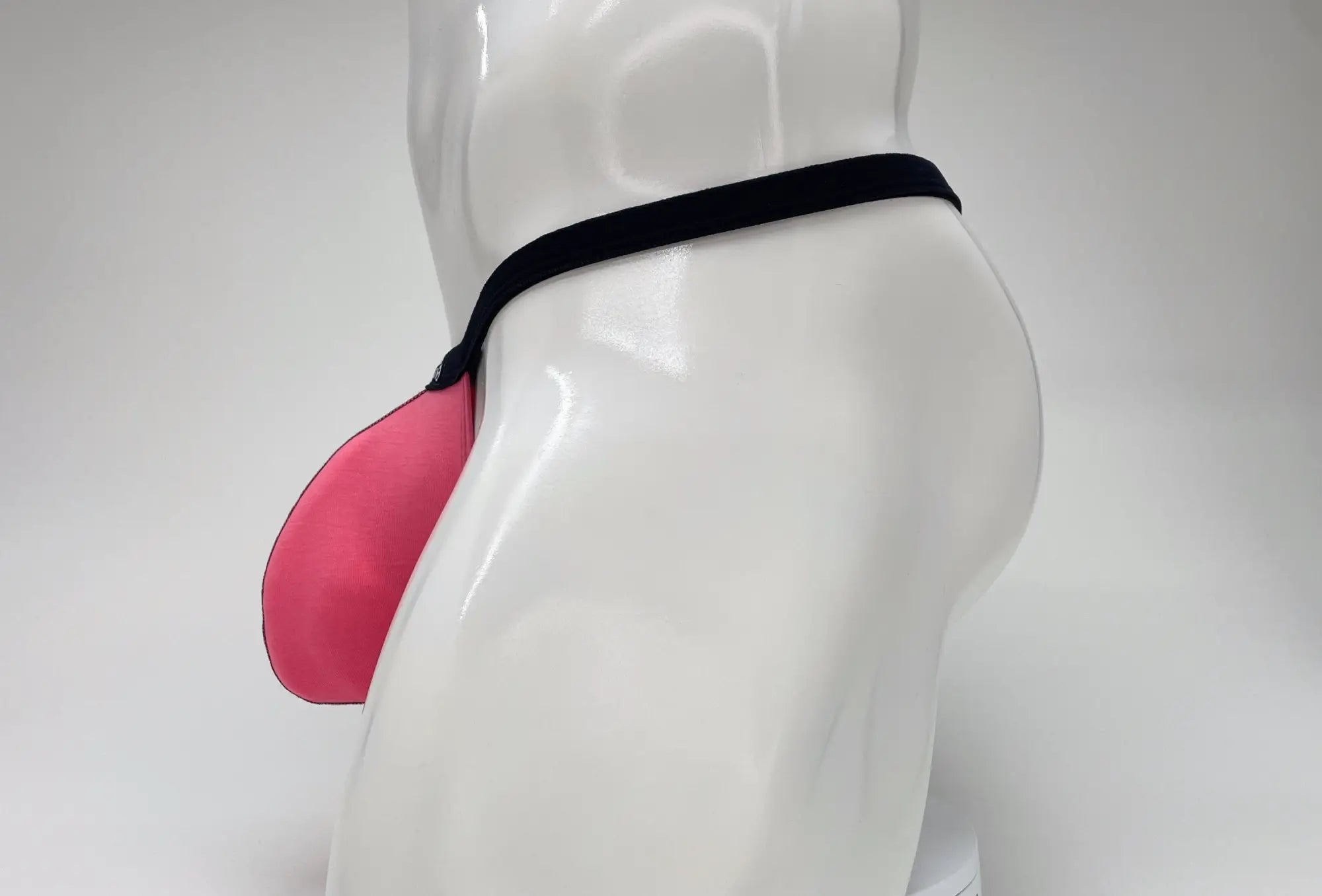 Pink wildmant modal micro thong big boy pouch made of silicone with a black elastic band for secure fit