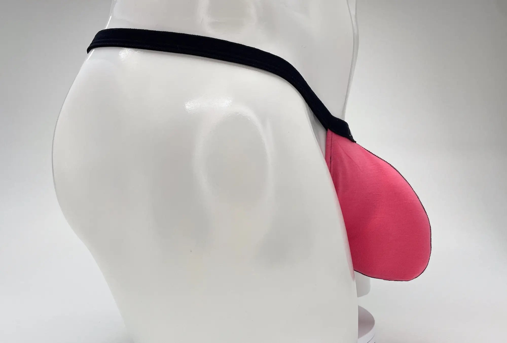 Pink silicone jockstrap with black elastic waistband wildmant modal micro thong big boy pouch pink front view
