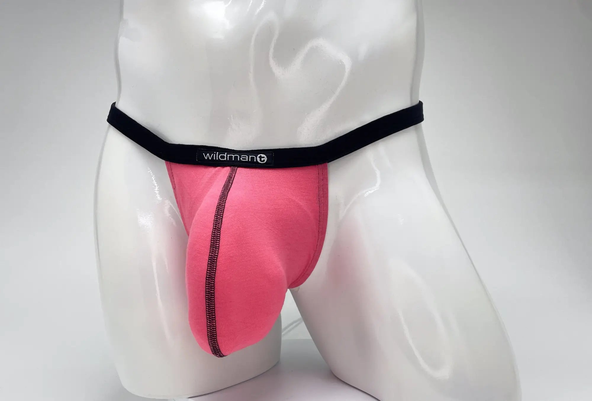 Pink wildman brand modal micro thong briefs with black elastic waistband and central seam detail front view