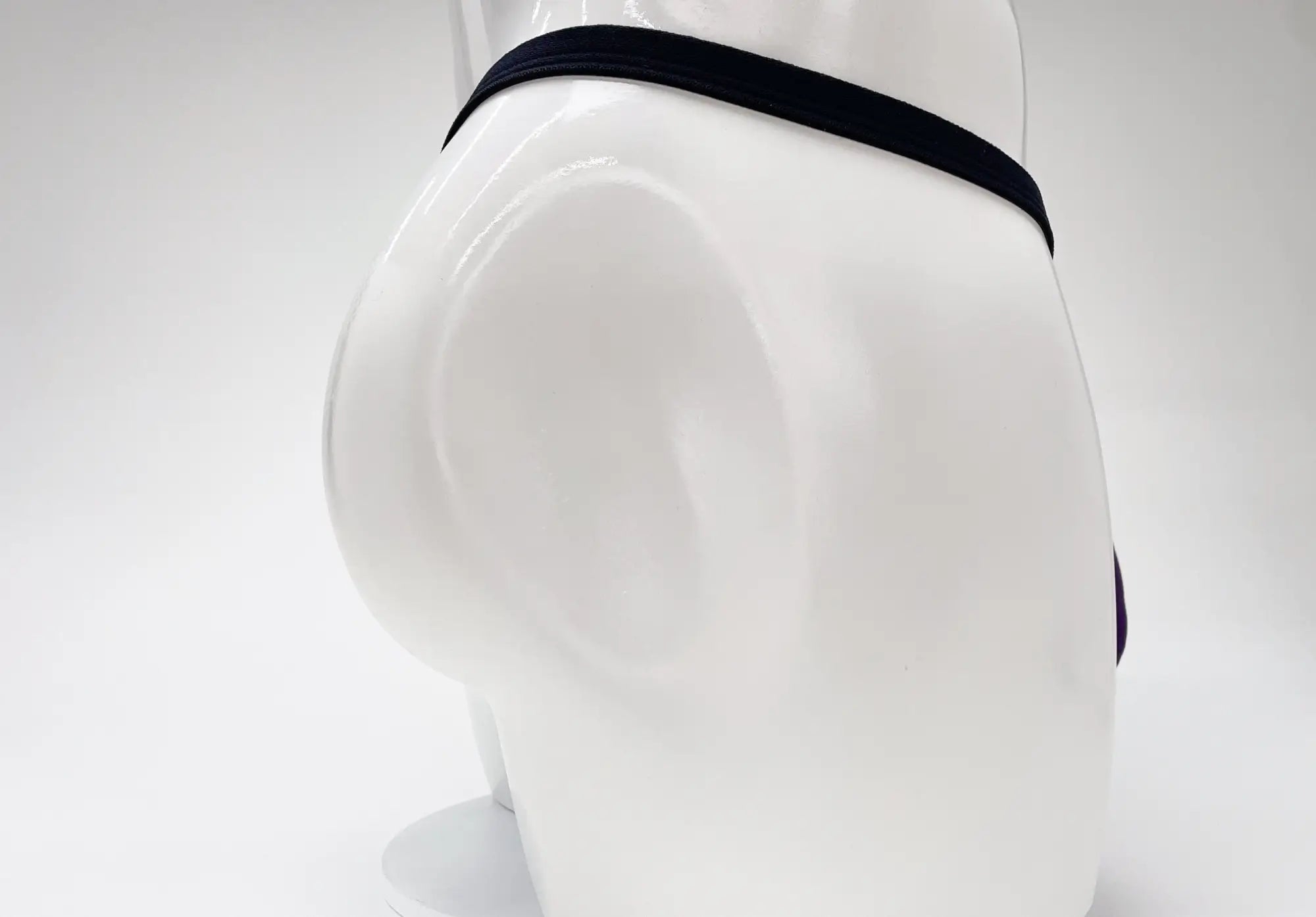 Black elastic waistband of wildmant modal micro thong big boy pouch purple displayed on a mannequin