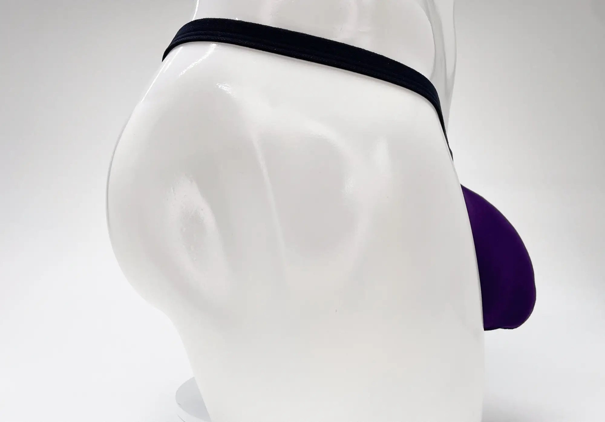 Purple and black wildmant modal micro thong big boy pouch displayed on a mannequin showing front view