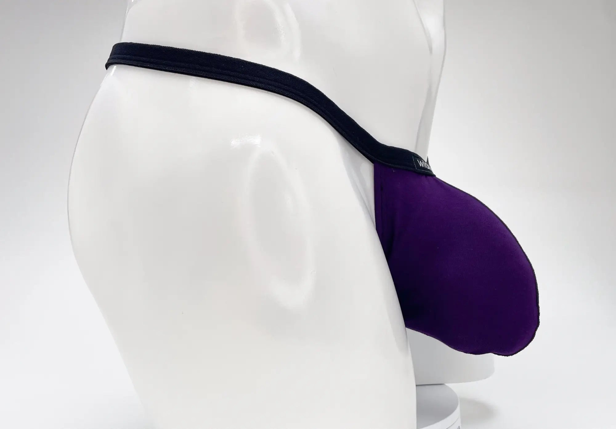 WildmanT modal micro thong big boy pouch in purple fabric with black elastic waistband for comfortable support