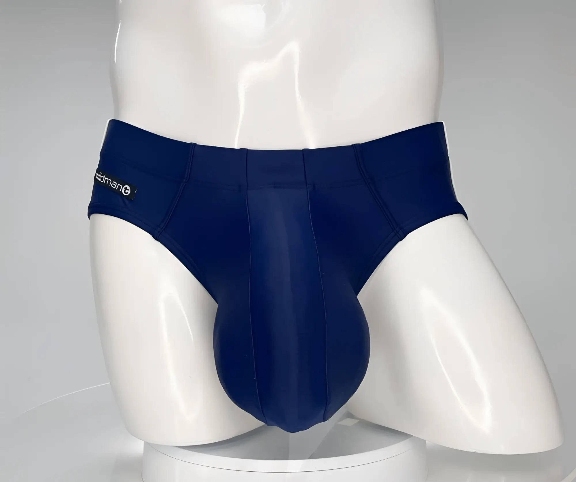 Wildmant monster cock swim brief navy in snug navy blue fabric with widman logo on the waistband for men