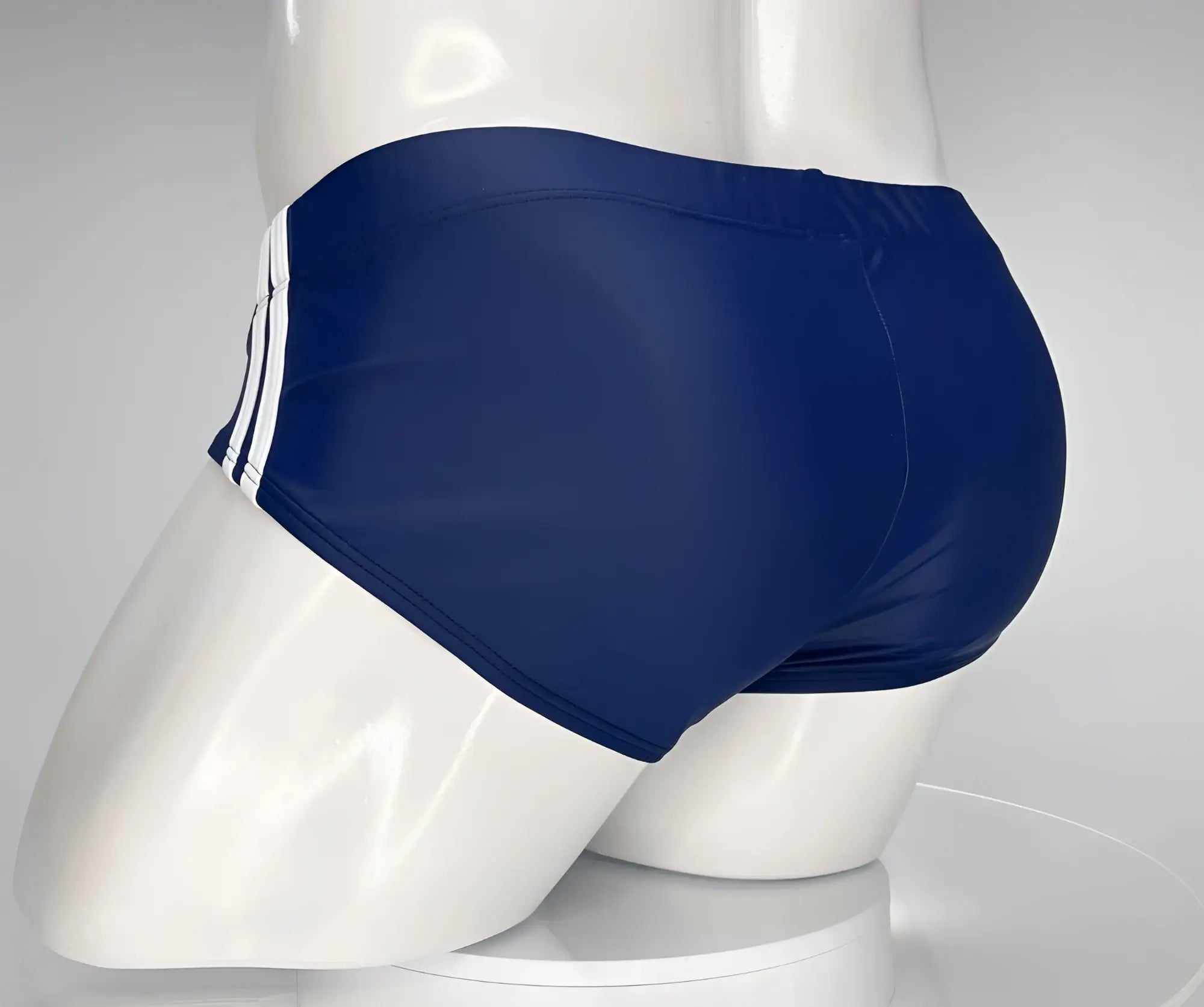 WildmanT monster cock swim brief navy blue with three white side stripes displayed on mannequin front view