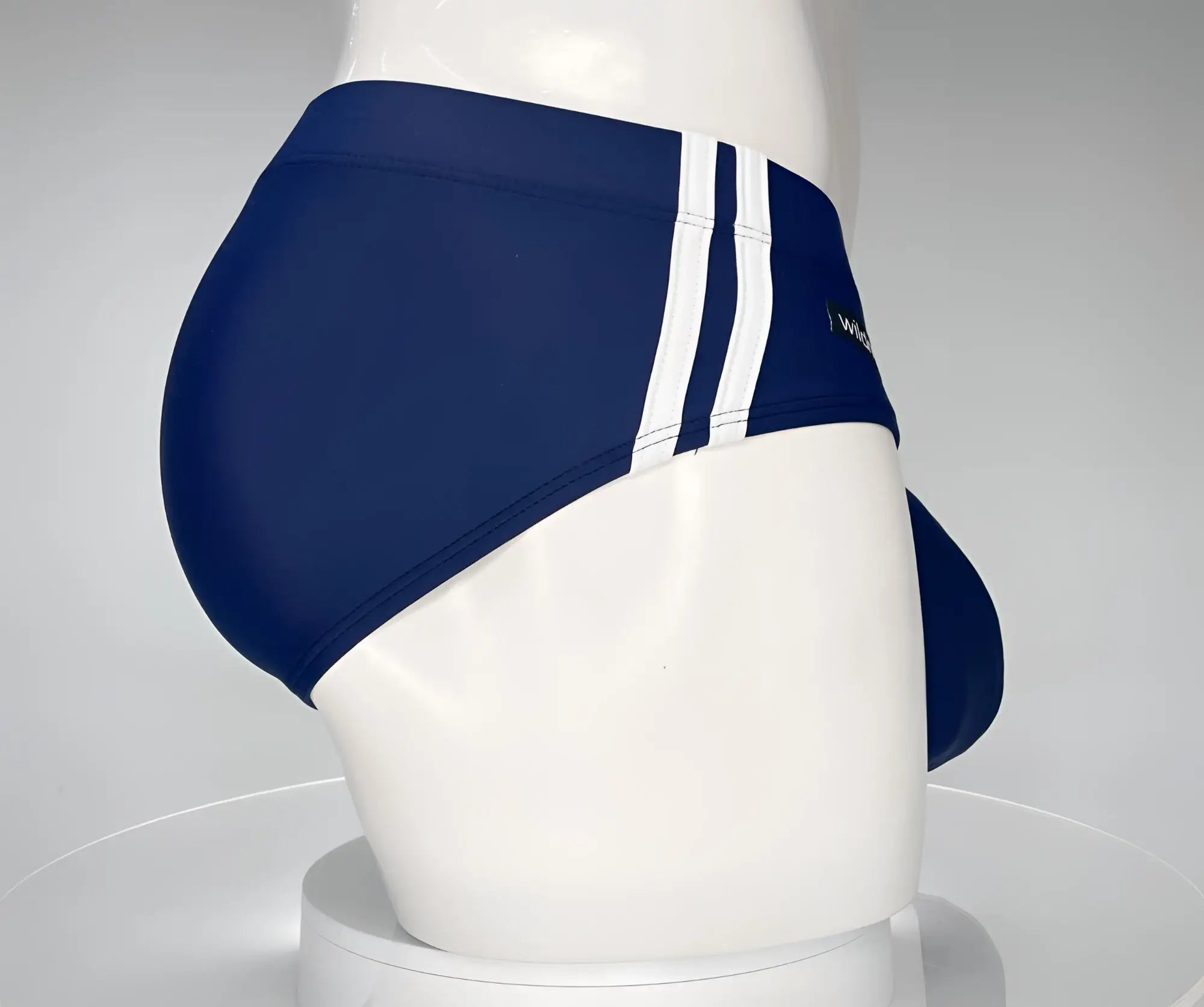 WildmanT Monster Cock swim brief navy in navy blue with three white vertical stripes ideal for beach wear