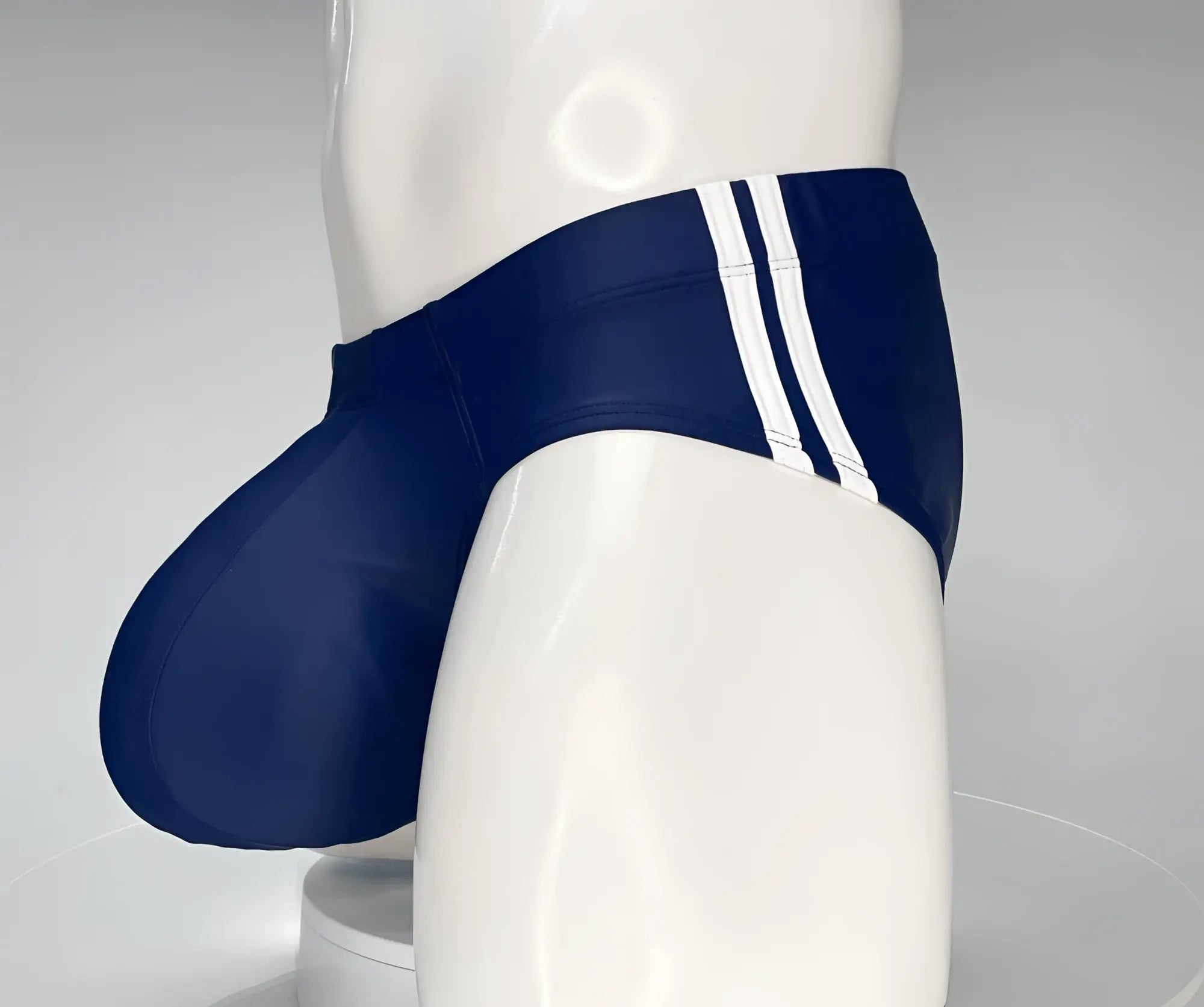 Wildmant monster cock navy swim brief in navy blue with three white side stripes designed for swimming and beachwear