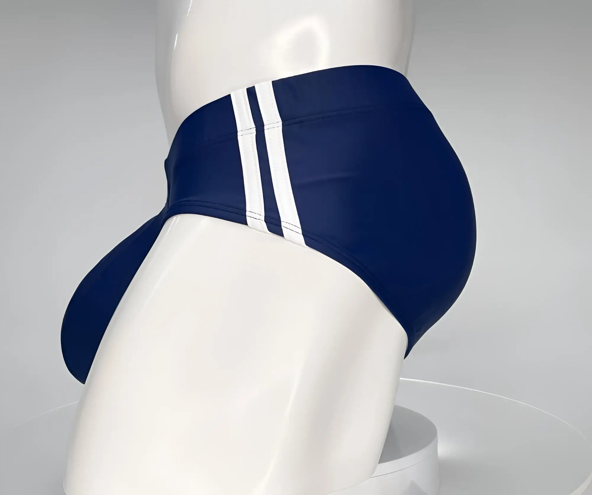 WildmanT monster cock swim brief navy made of navy blue fabric with three white vertical stripes on the side