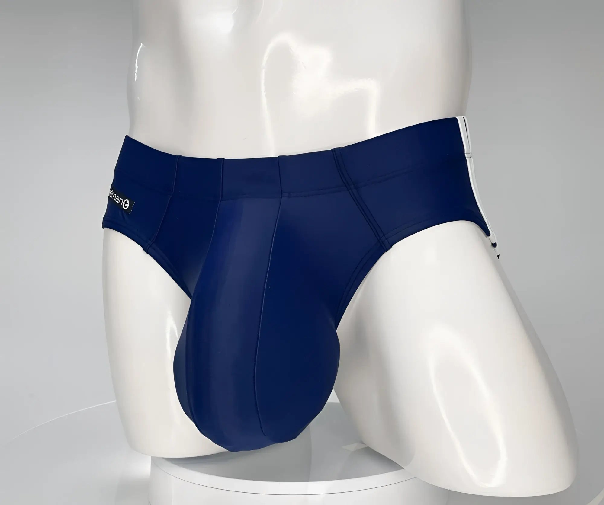 Navy WildmanT monster cock swim brief with white side stripes and subtle waistband brand logo