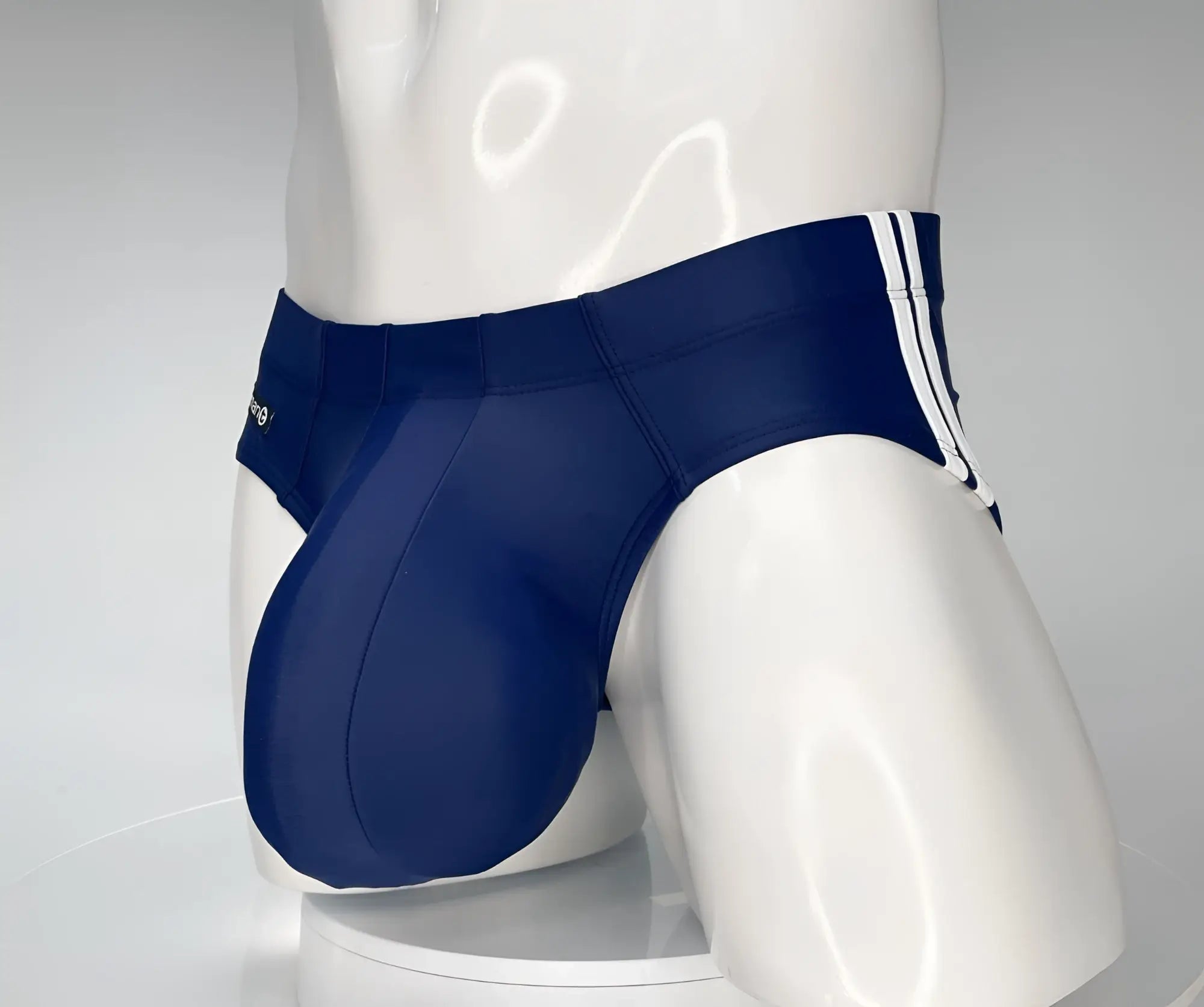 Navy blue WildmanT Monster Cock swim brief with white striped side panels designed for swimming and beachwear