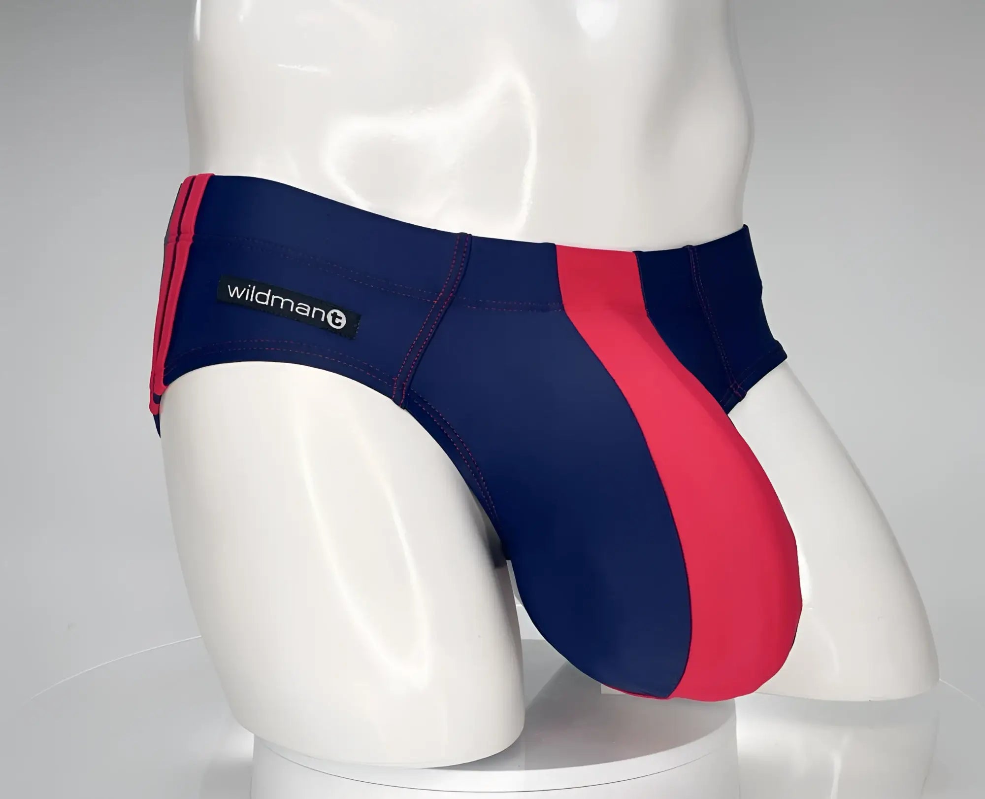 WildmanT monster cock swim brief in navy and red striped design with wildman brand label for swimwear use