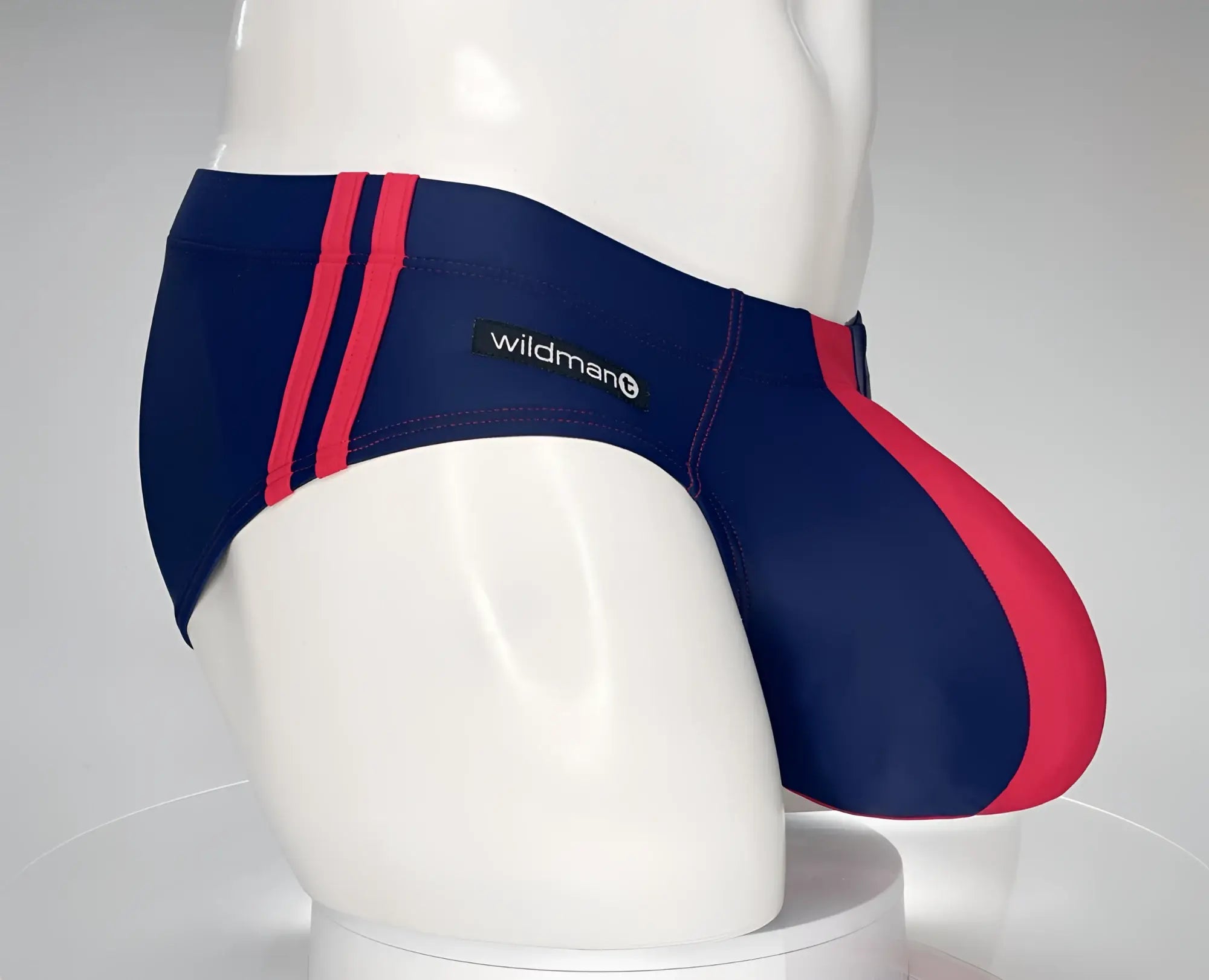 Navy blue and red striped Wildman swim briefs featuring a Monster Cock design and Wildman brand label