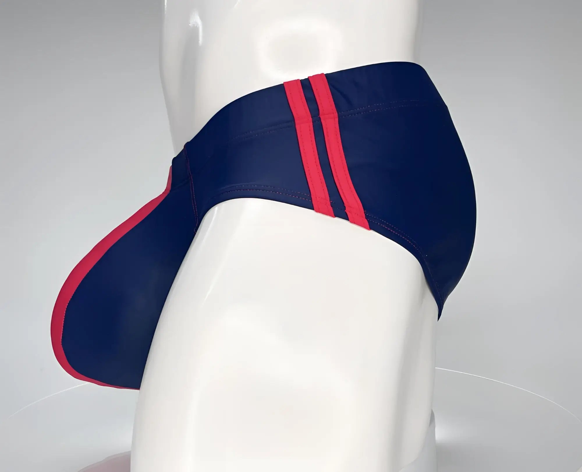 WildmanT monster cock swim brief navy with bold red side stripes designed for swimwear and beachwear use