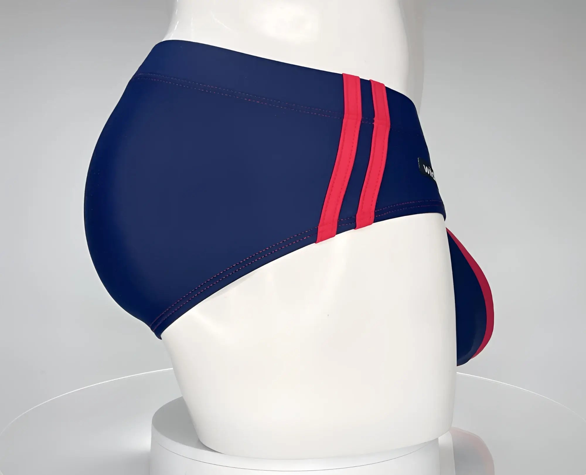 Wildmant monster cock navy swim brief in navy blue with bold red side stripes made of smooth stretchy fabric
