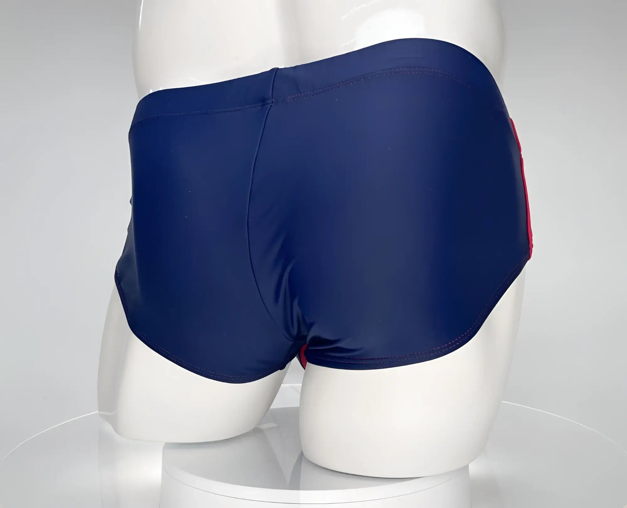 Navy blue wildmant monster cock swim brief with a red side stripe designed for comfortable swimwear use