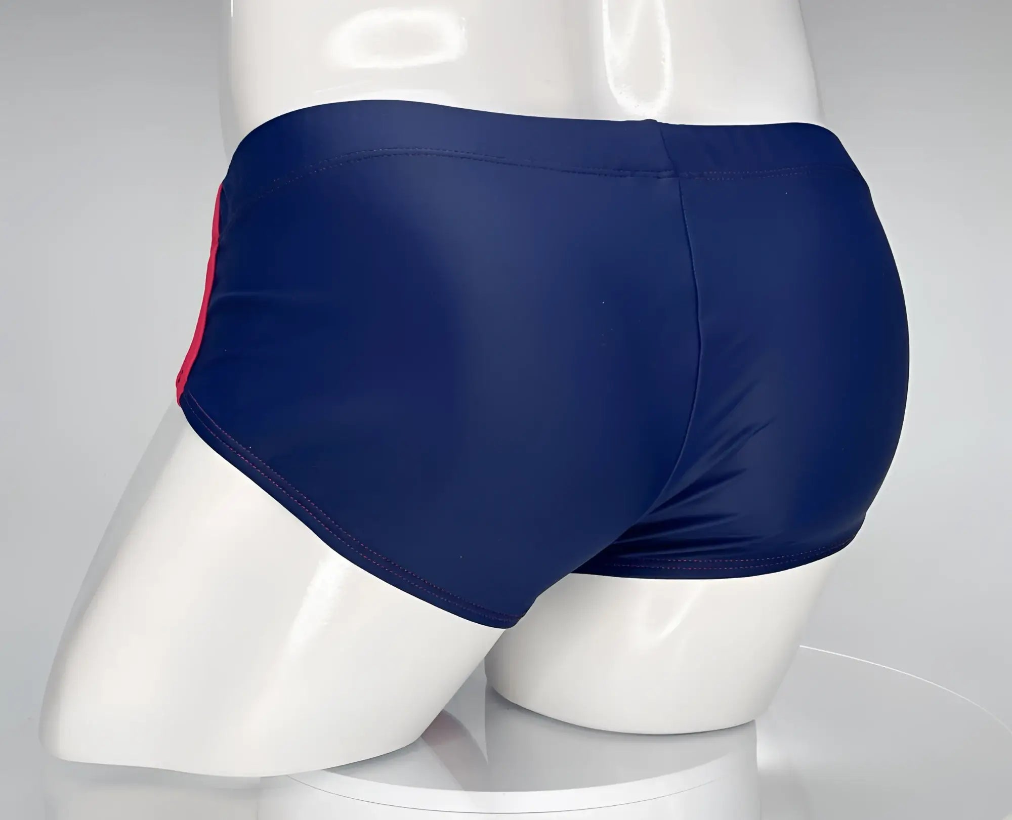 Wildmant monster cock swim brief in navy blue nylon with red side stripe designed for swimming and beachwear