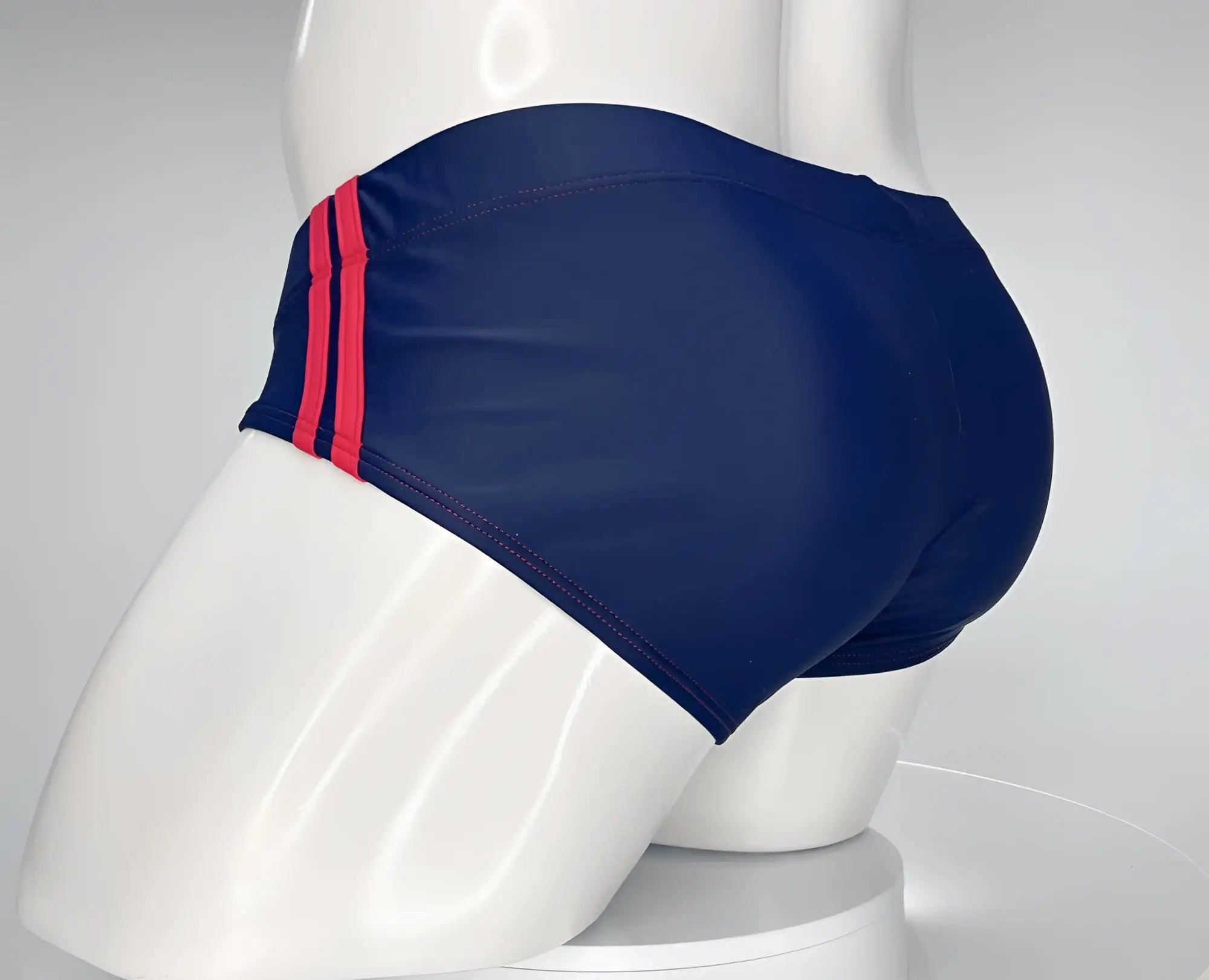 WildmanT monster cock swim brief navy red with navy blue fabric and three bold red stripes along the side seam