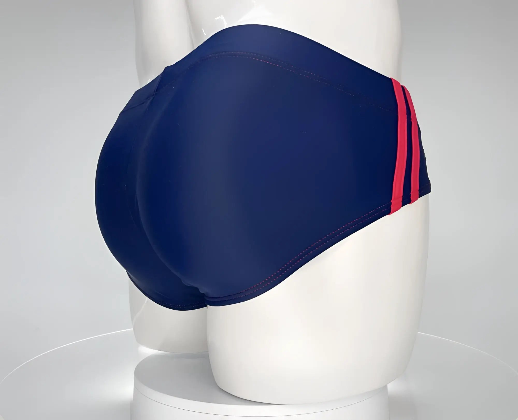 Navy blue wildmant monster cock swim brief with bold red side stripes designed for swimming and beachwear