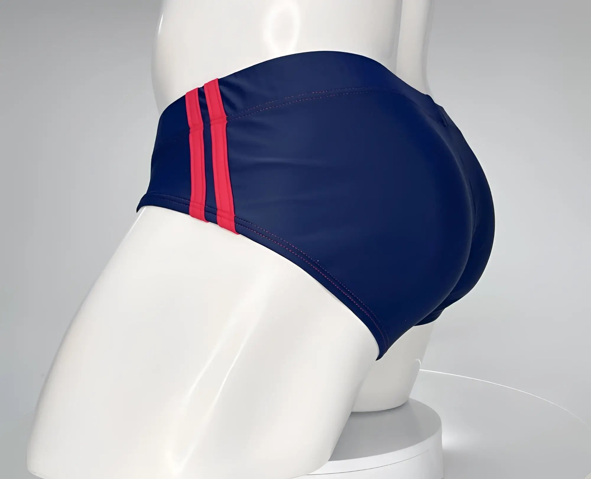 WildmanT monster cock swim brief navy with bold red side stripes designed for comfortable swimwear use