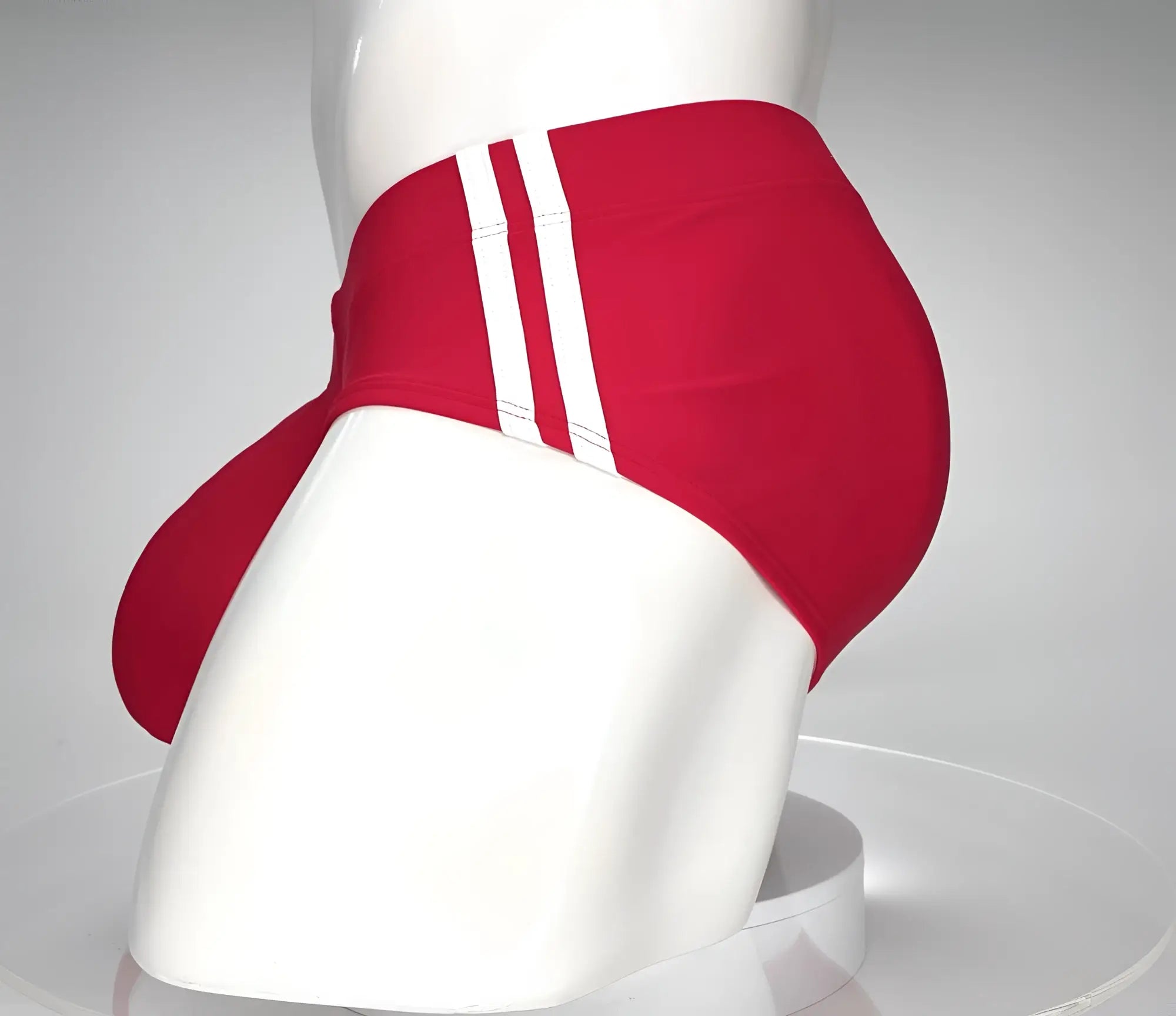 Wildmant monster cock swim brief in red athletic fabric with three white stripes down the side for swimming