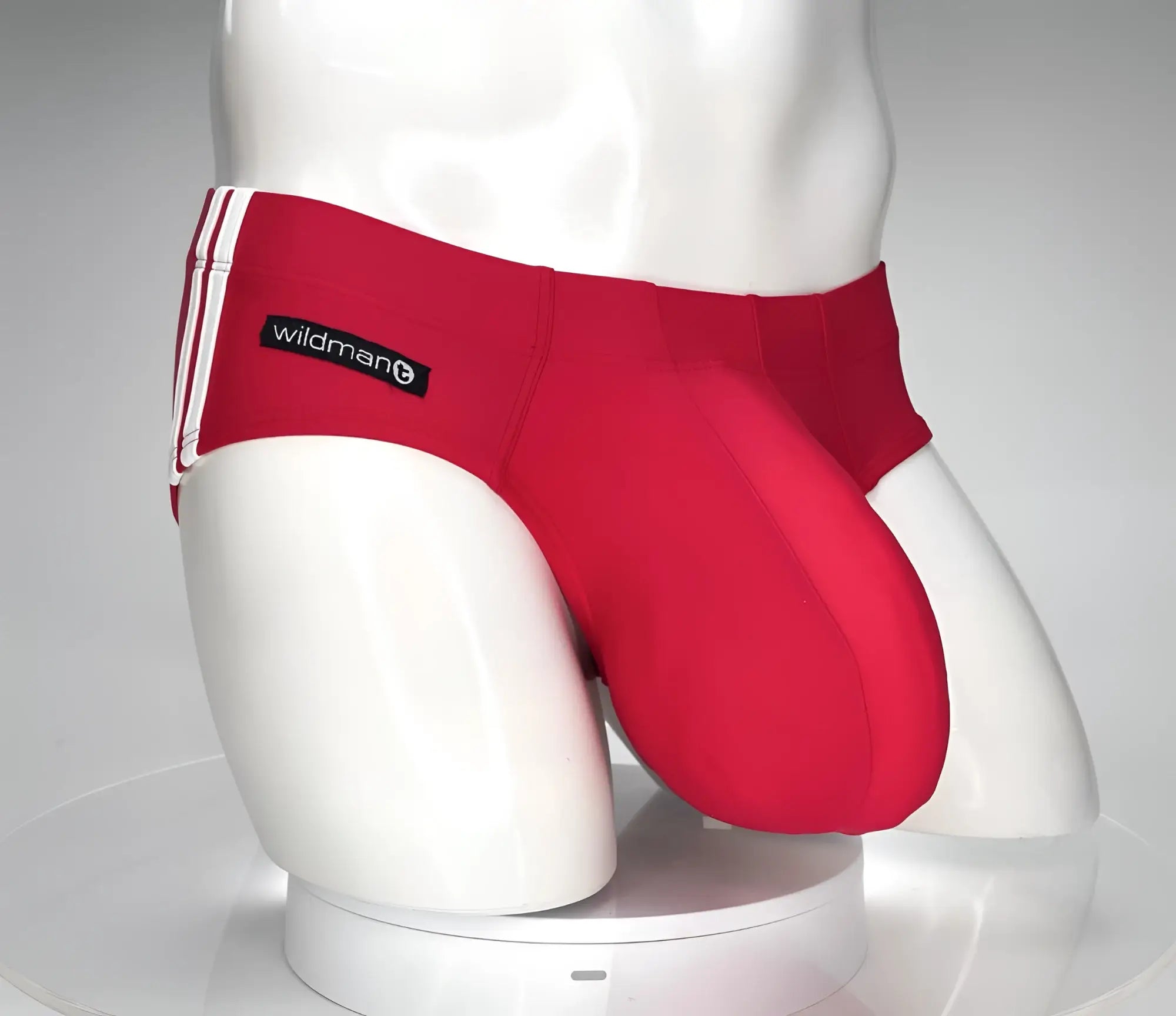 Red wildmant monster cock swim brief with white side stripes and black brand label designed for athletic use