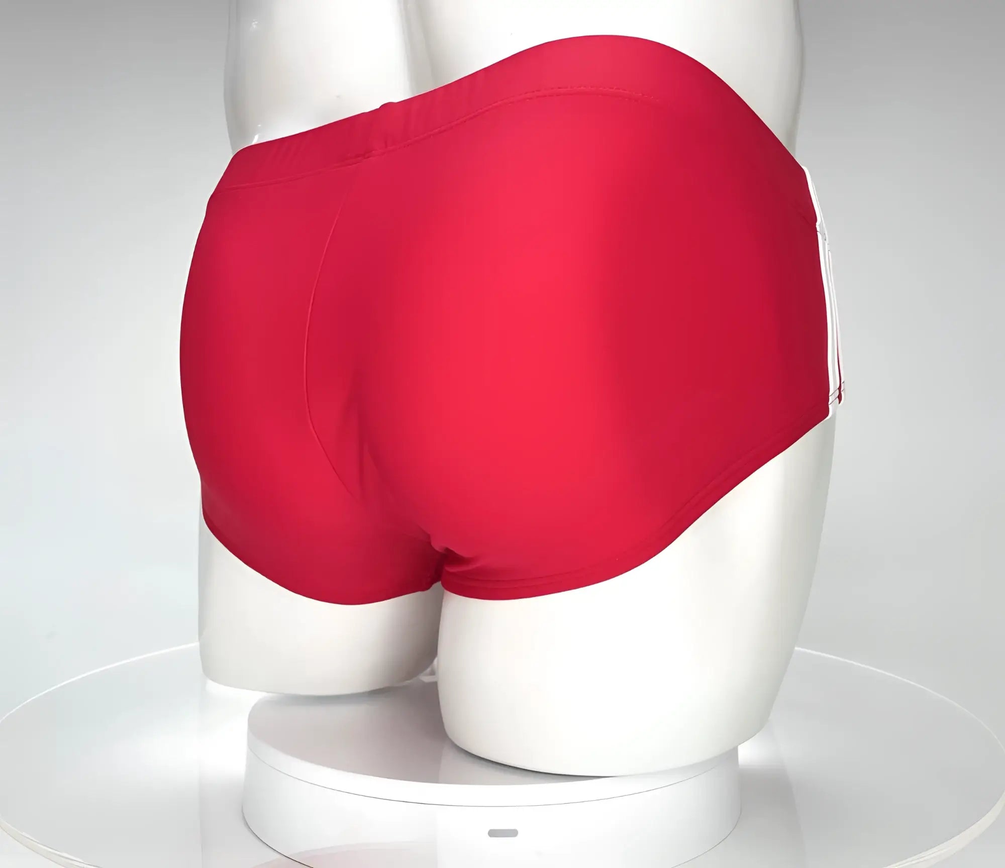 Bright red WildmanT Monster Cock swim brief with smooth form-fitting fabric and subtle white side stripes