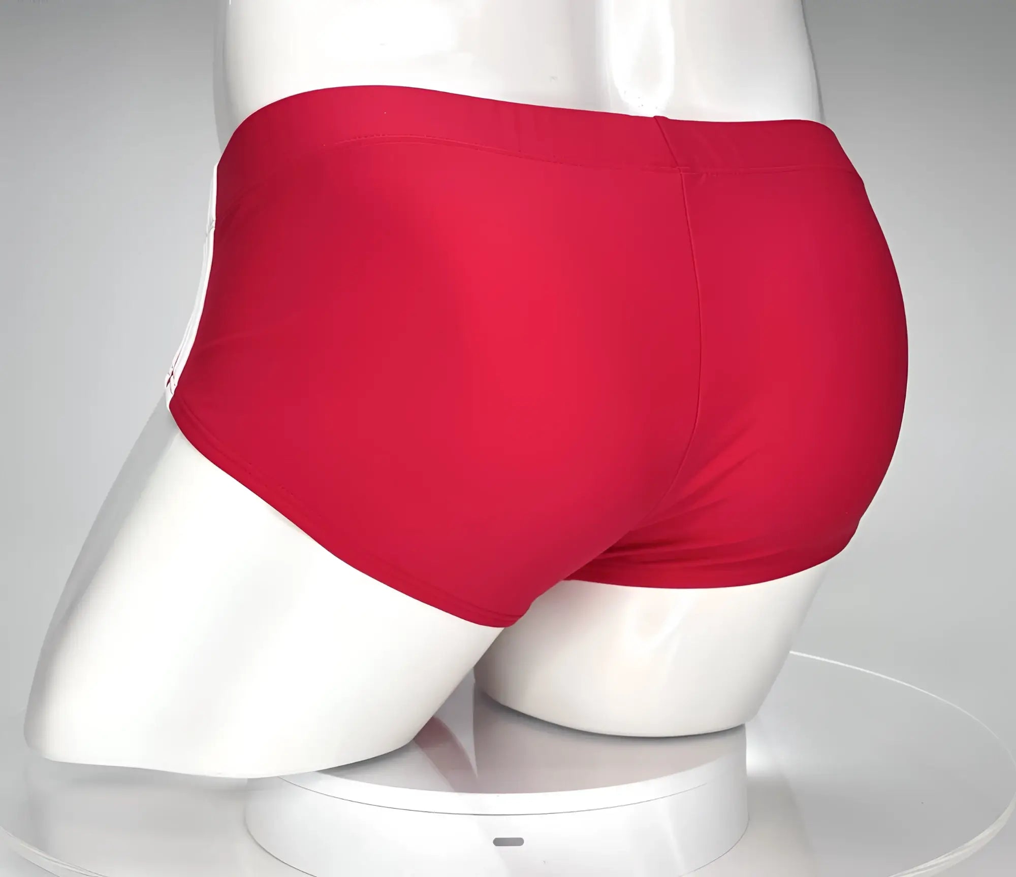 WildmanT Monster Cock swim brief in red with smooth form-fitting fabric and subtle white stripe along the side seam