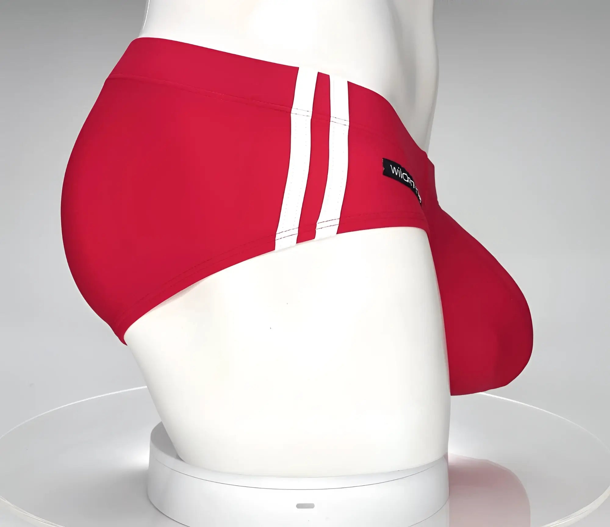 Wildmant monster cock swim brief in red with three white side stripes and black wicked brand label